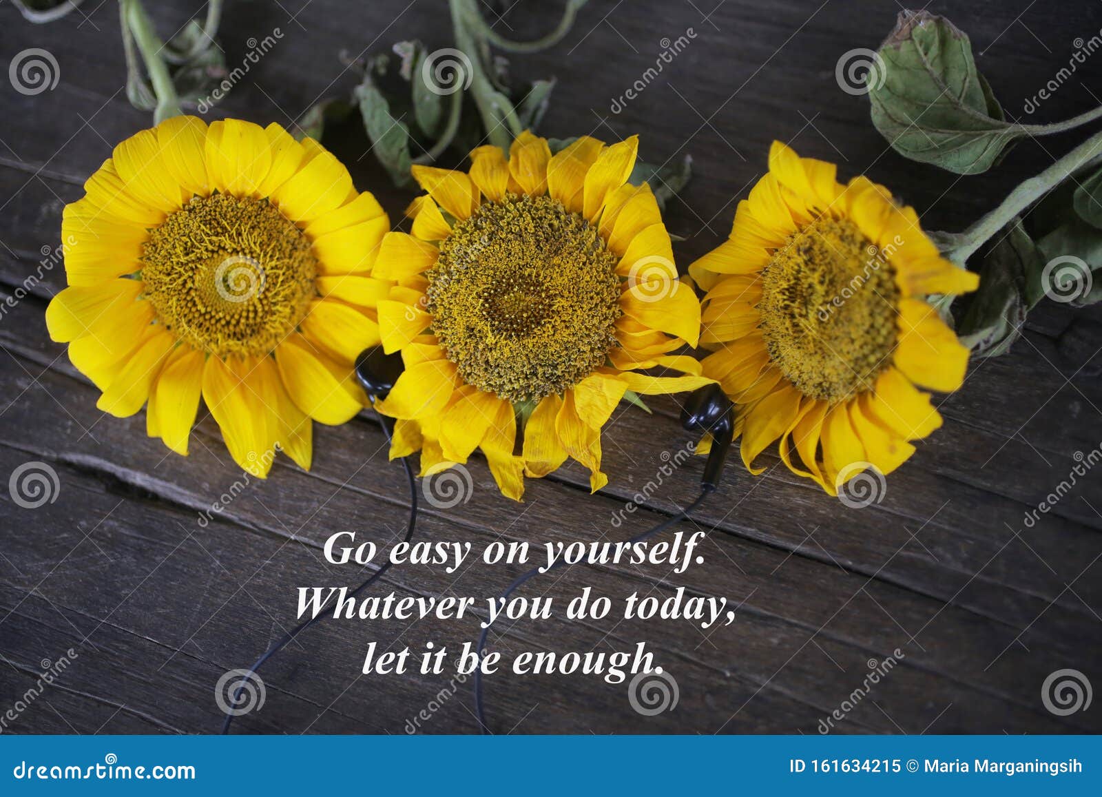 inspirational words with yellow sun flowers - go easy on yourself. whatever you do today, let it be enough.