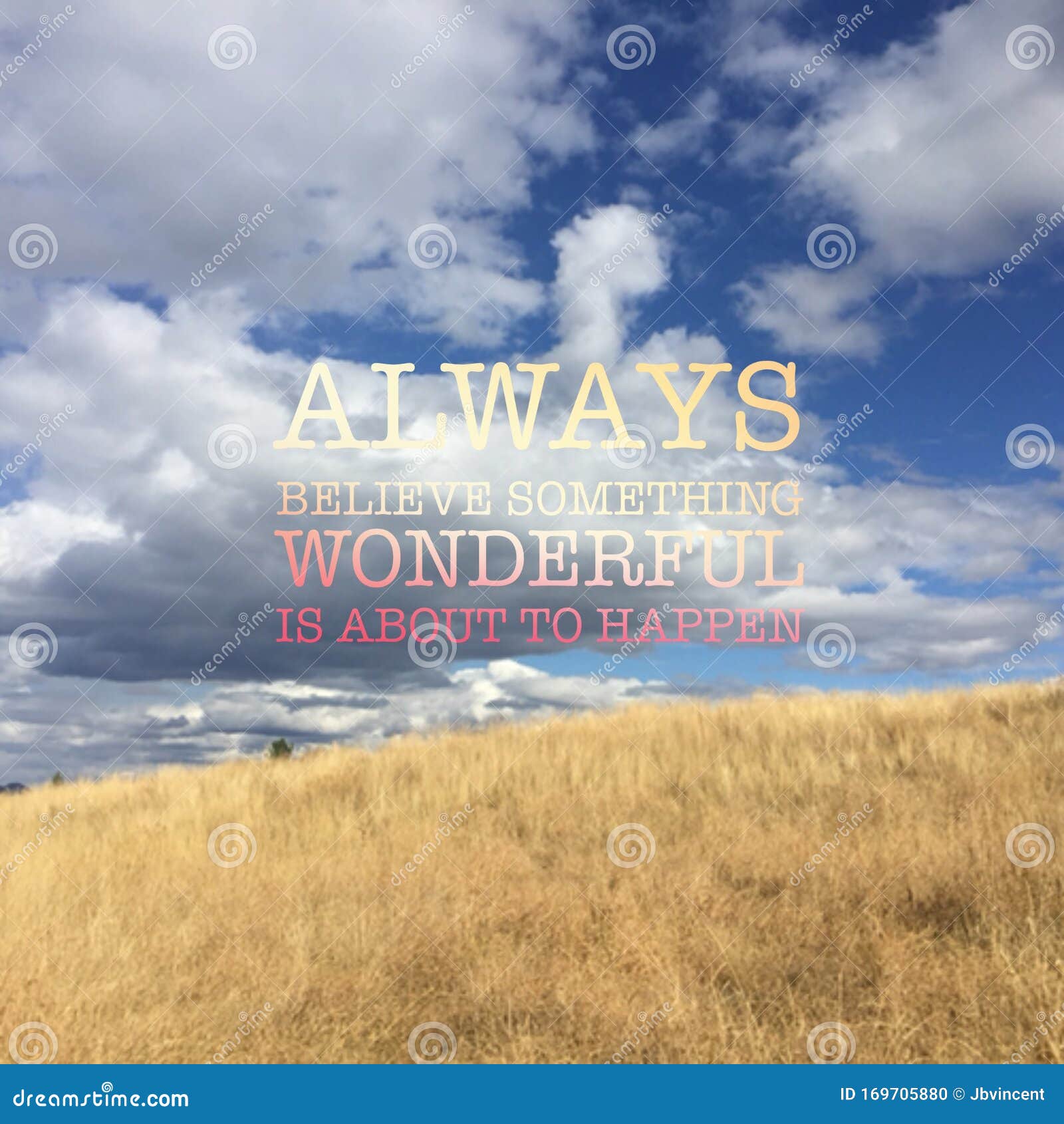 inspiring colourful text on landscape image of grass field with white clouds and blue sky