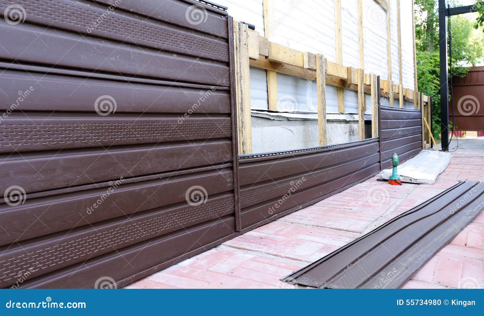 Installation of Brown Plastic Siding on the Facade Stock Photo Image