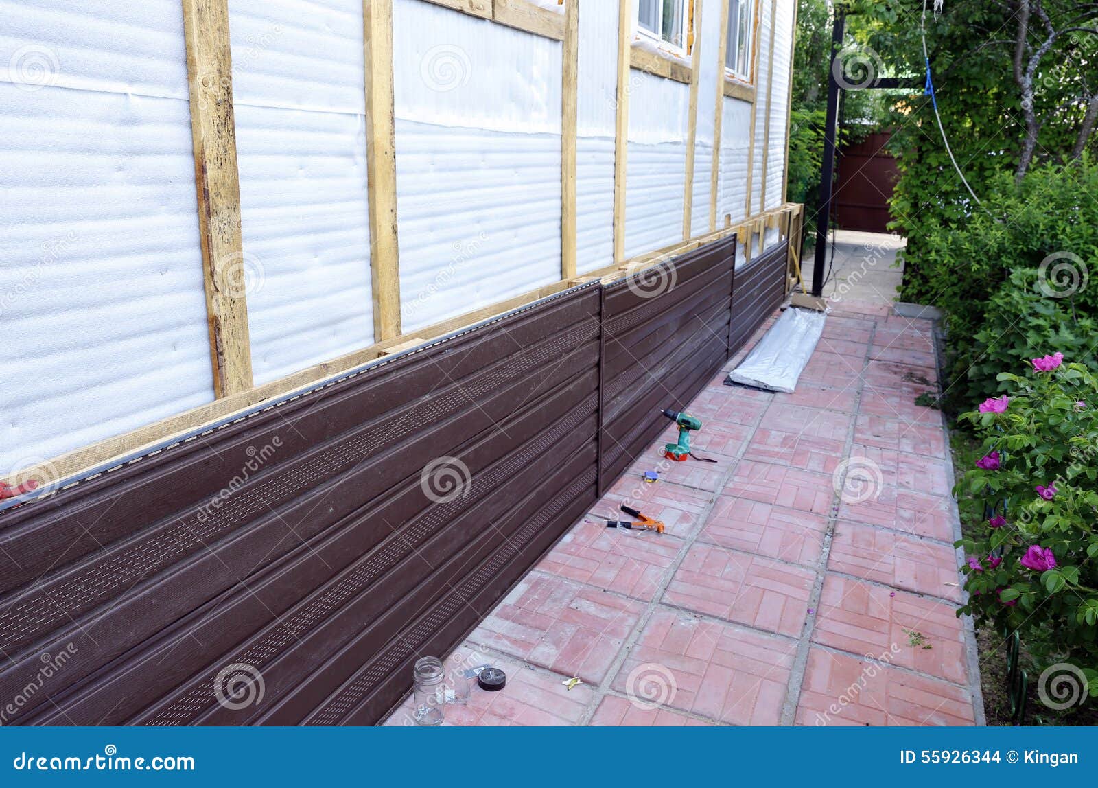 Installation of Brown Plastic Siding on the Facade Stock Photo Image