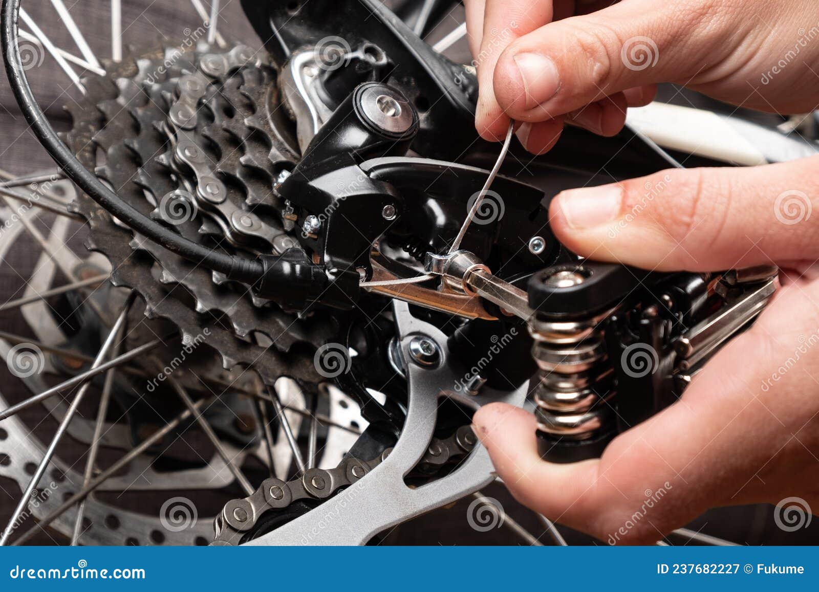Installation of a Cable for Gear Shifting on a Bicycle Stock Image