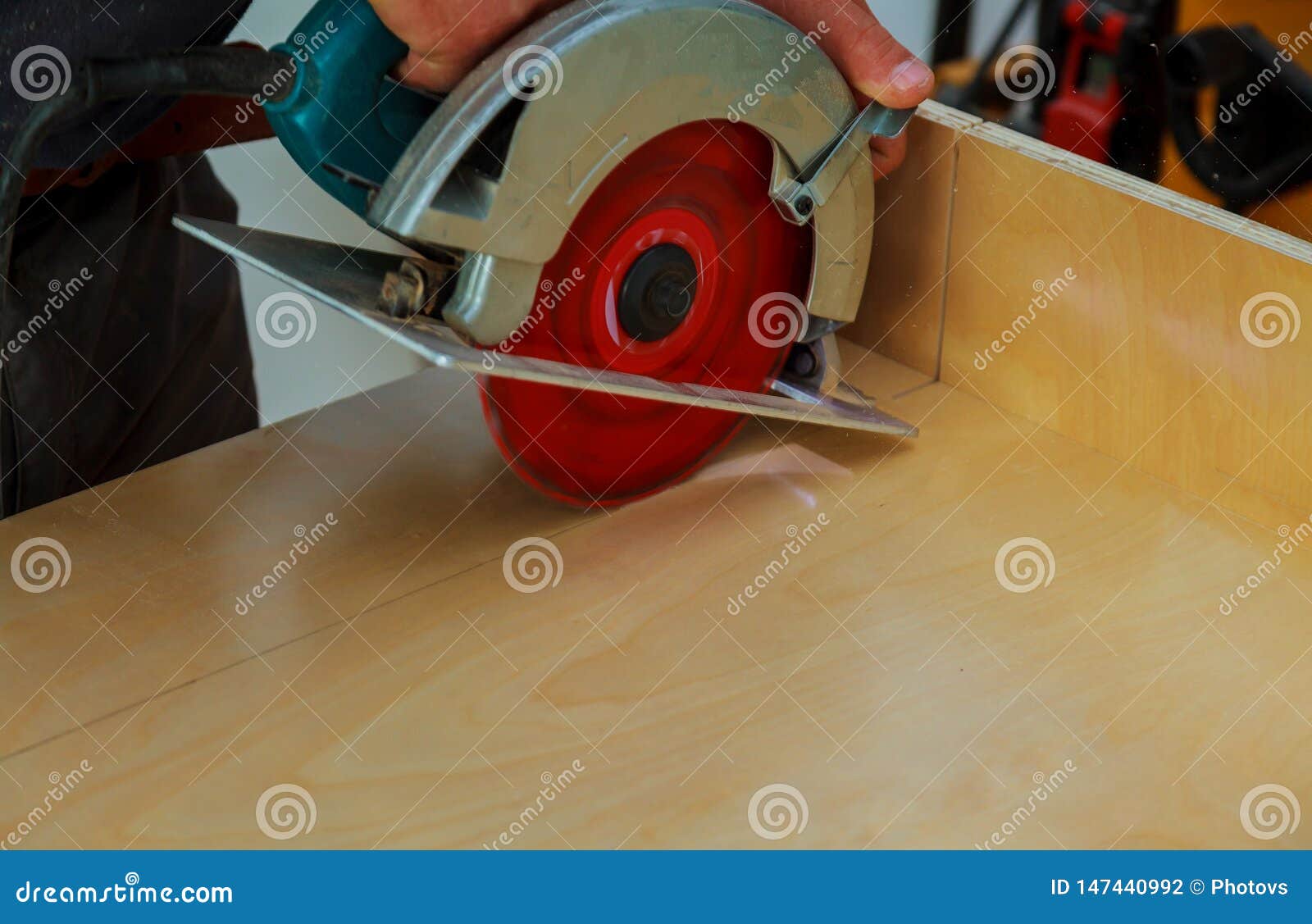 Installation of Kitchen. Worker Using Circular Electro Saw Cutting