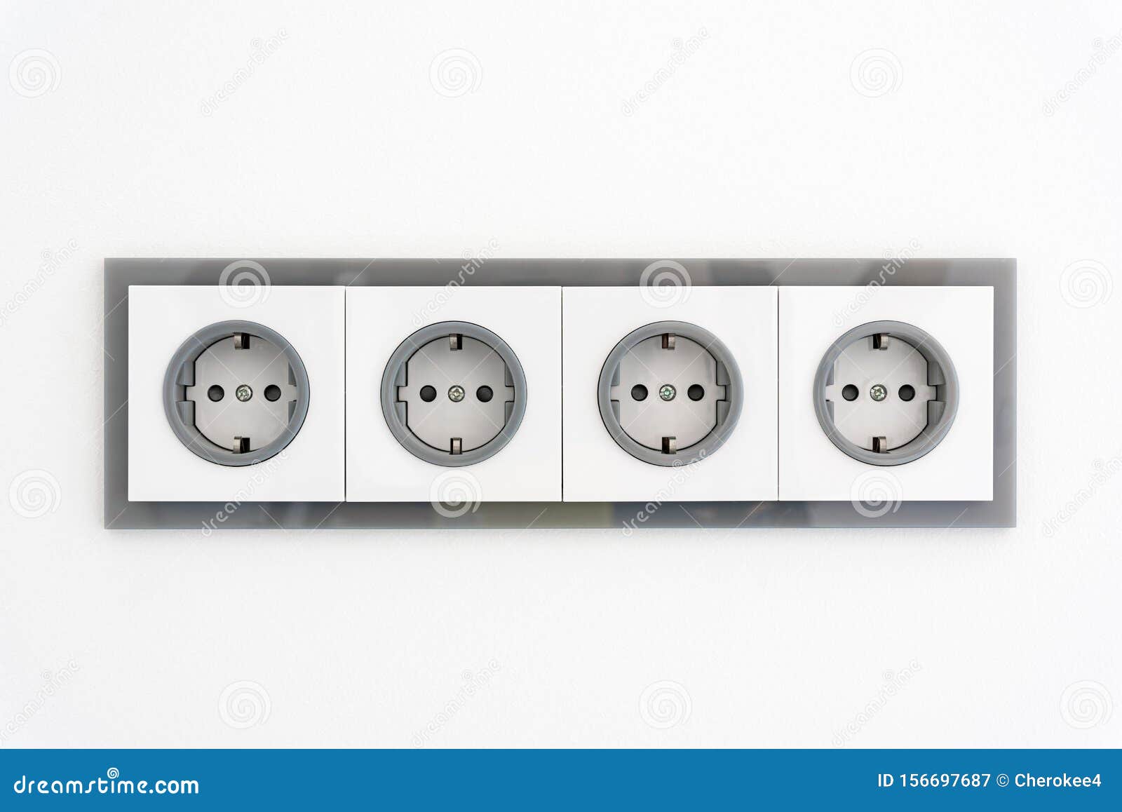 Installation Modern Sockets on a Painted Wall Closeup. Grey and White