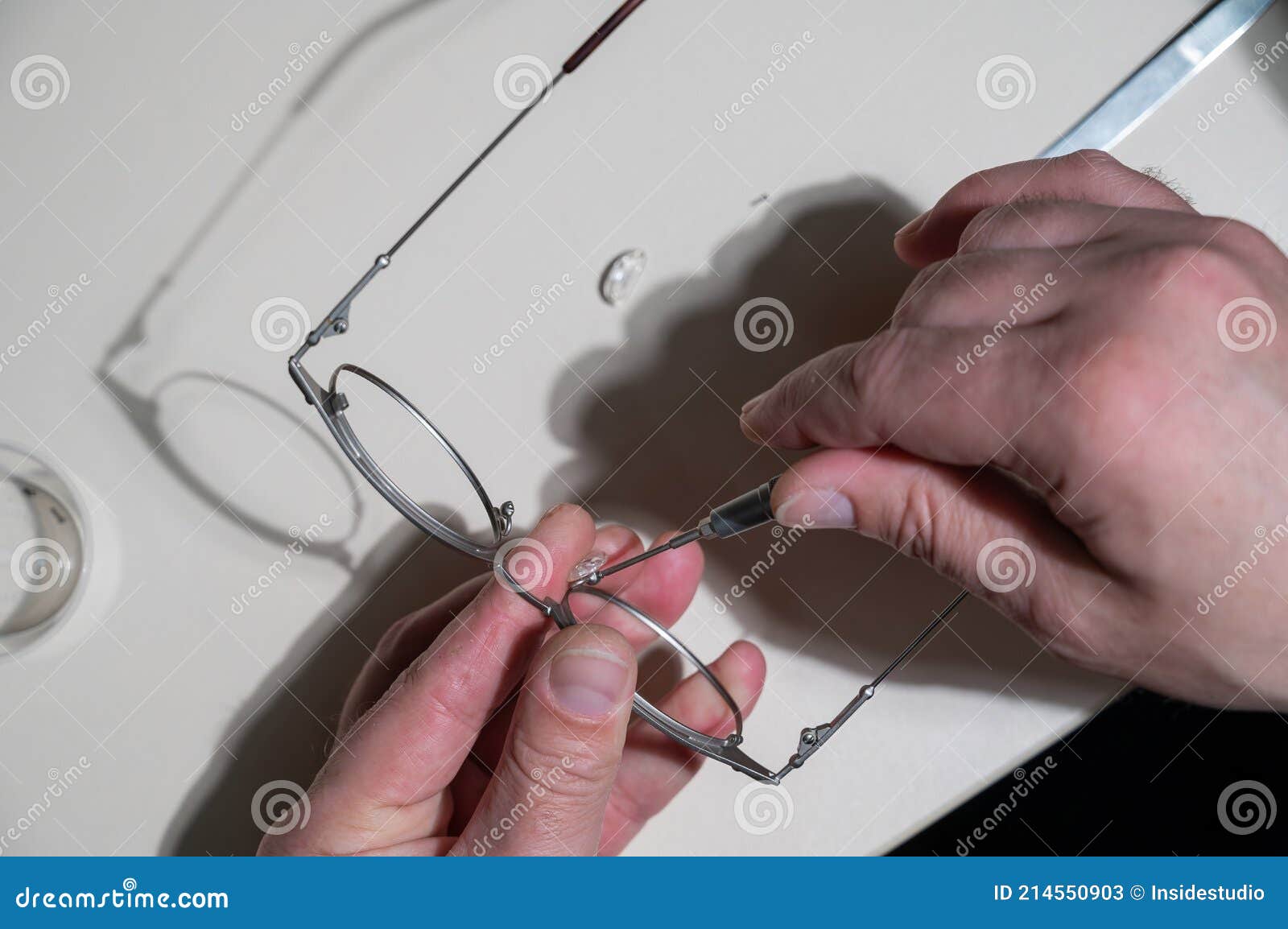 Installation of Nose Pads in Glasses. a Male Technician Repairs Broken