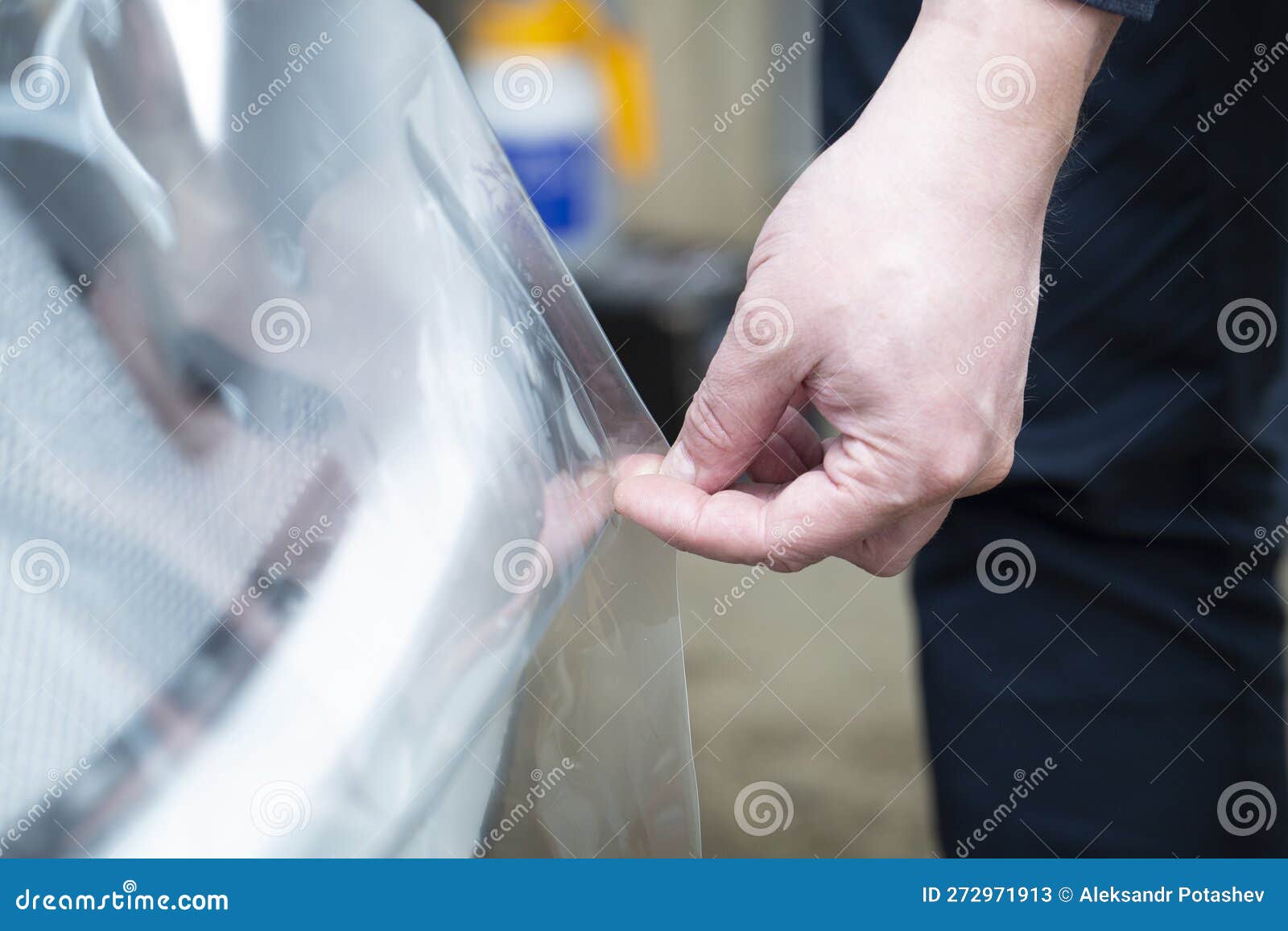 Installation of a Protective Film for Car Paint.the Workers Install a