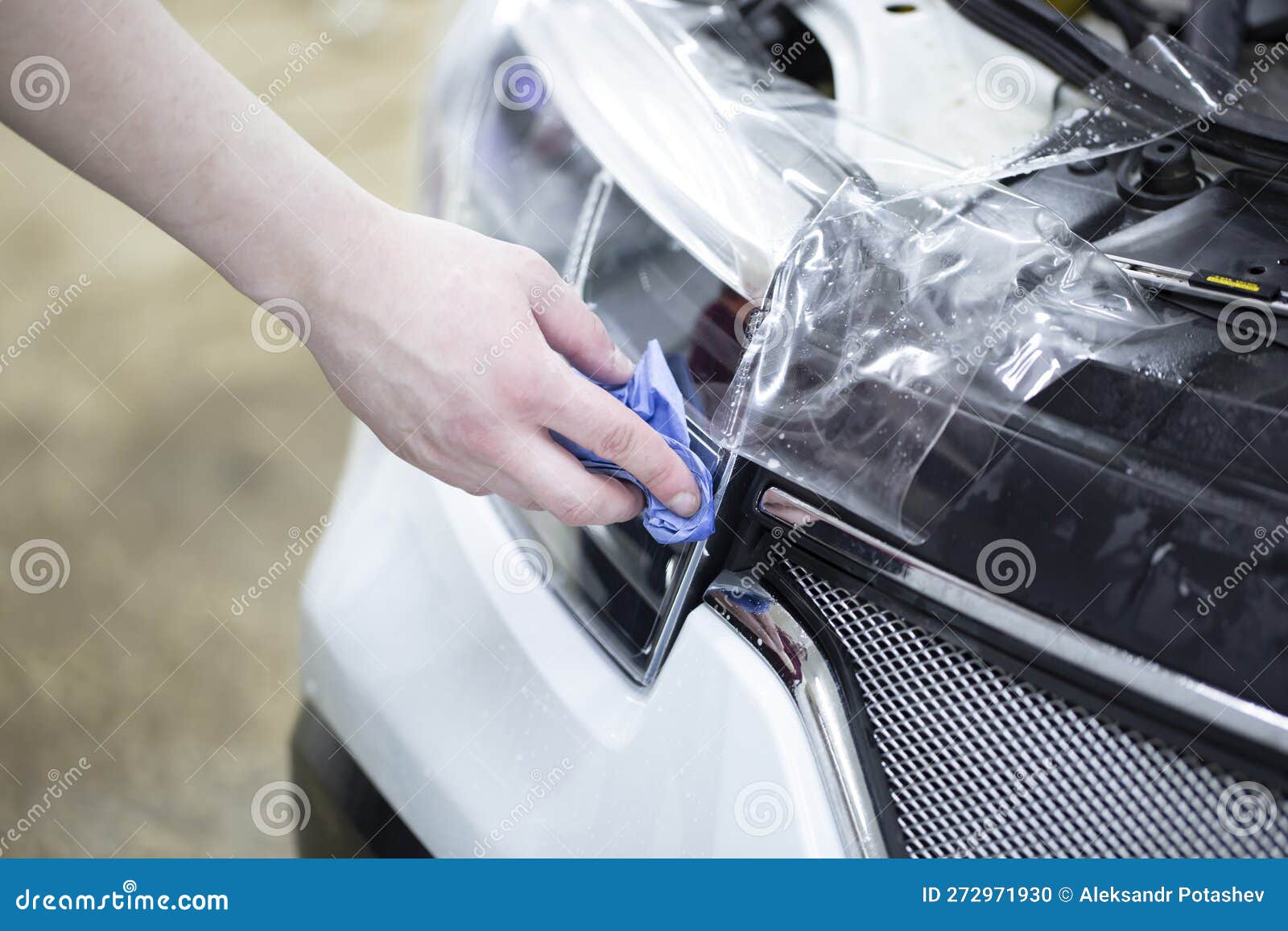 Installation of a Protective Film for Car Paint.the Workers Install a