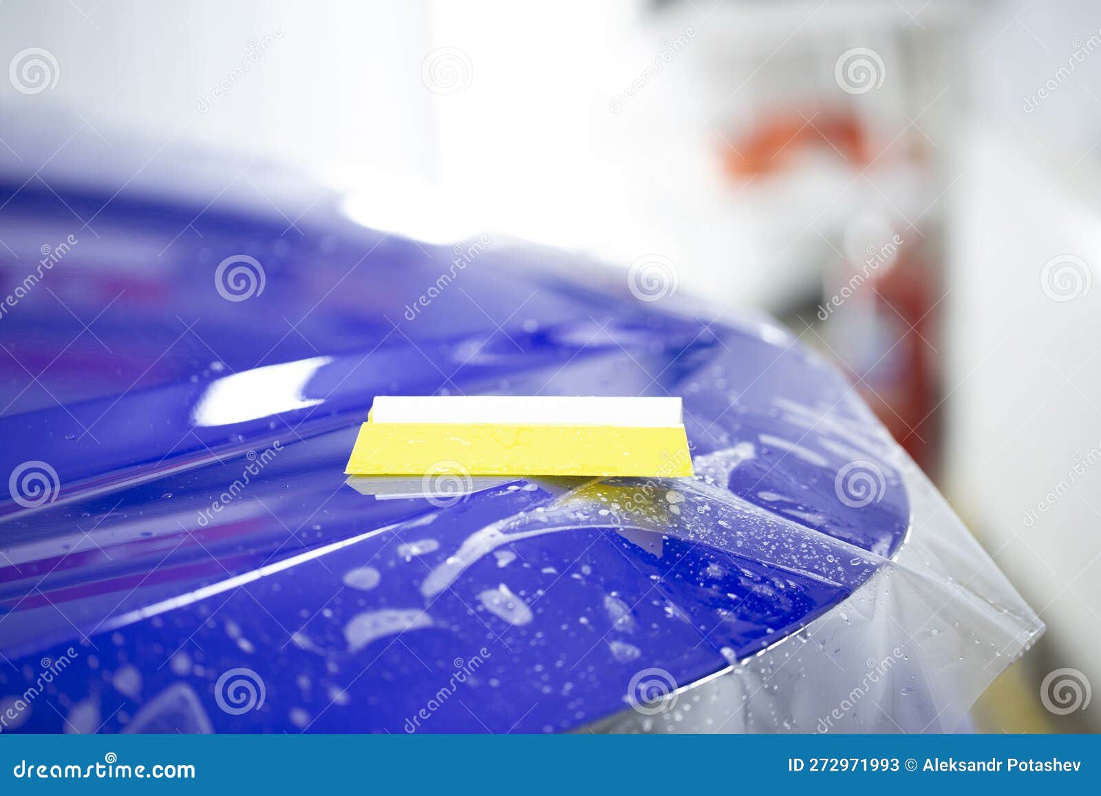 Installation of a Protective Film for Car Paint.the Workers Install a