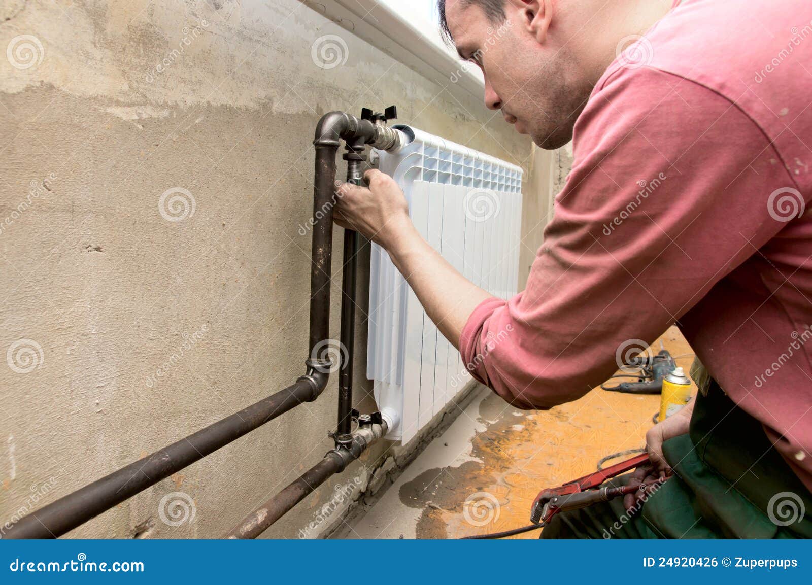 Installation of a radiator stock photo. Image of pipe 24920426
