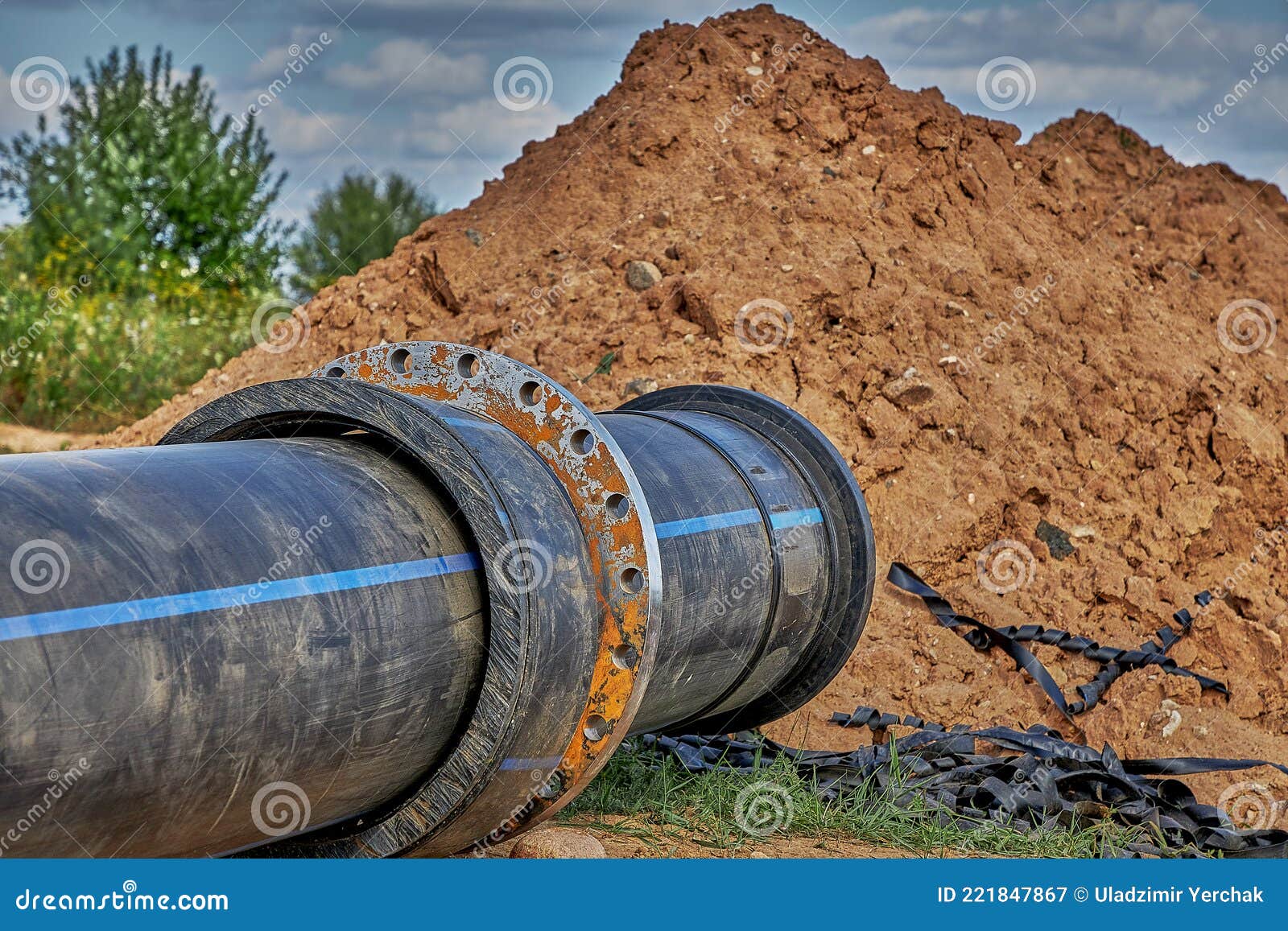 Installation of the Water Supply Network. a Plastic Water Pipe Lies on the Grass, Ready To Go