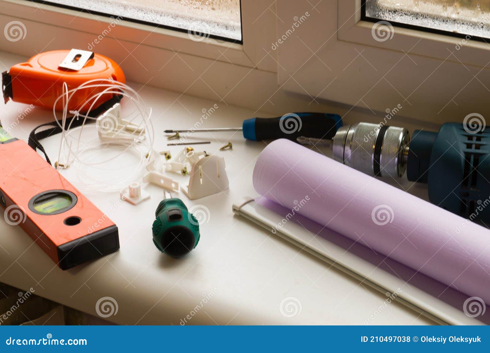 installation of a window roller with a holder. installation tool. screwdrivers, drill, level, roller shutter and fasteners.