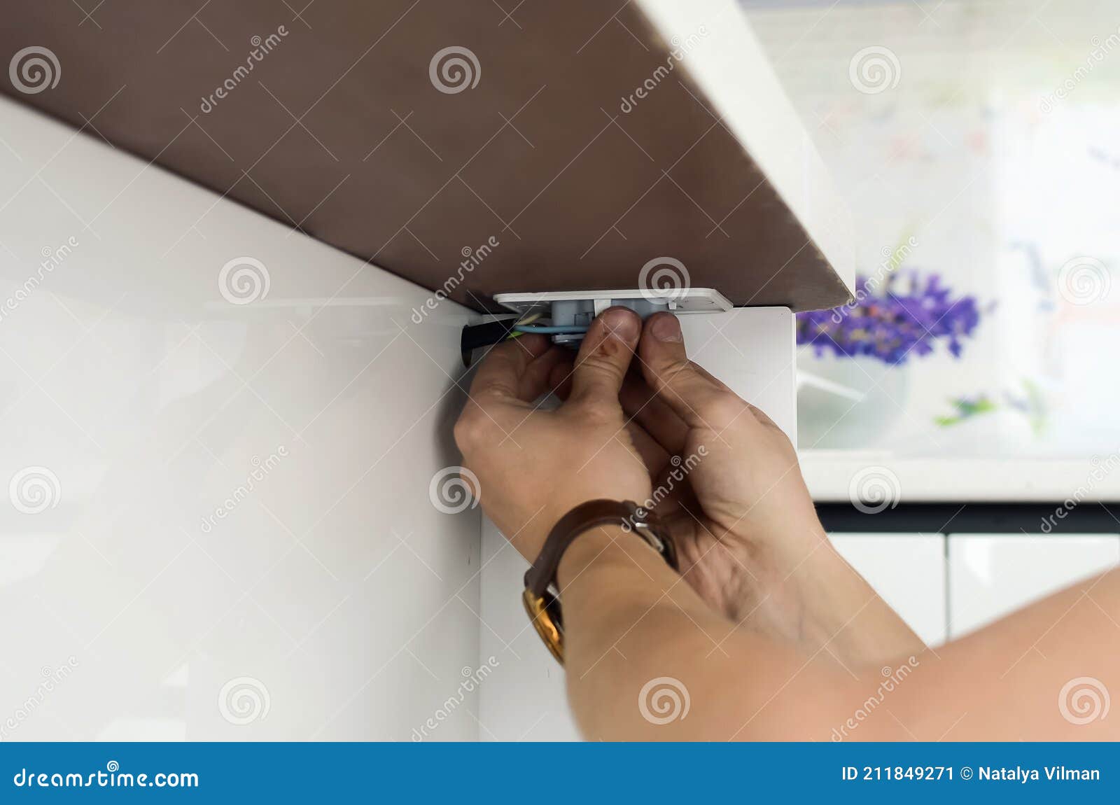 Installing an Electrical Outlet on a Kitchen Countertop Stock Image