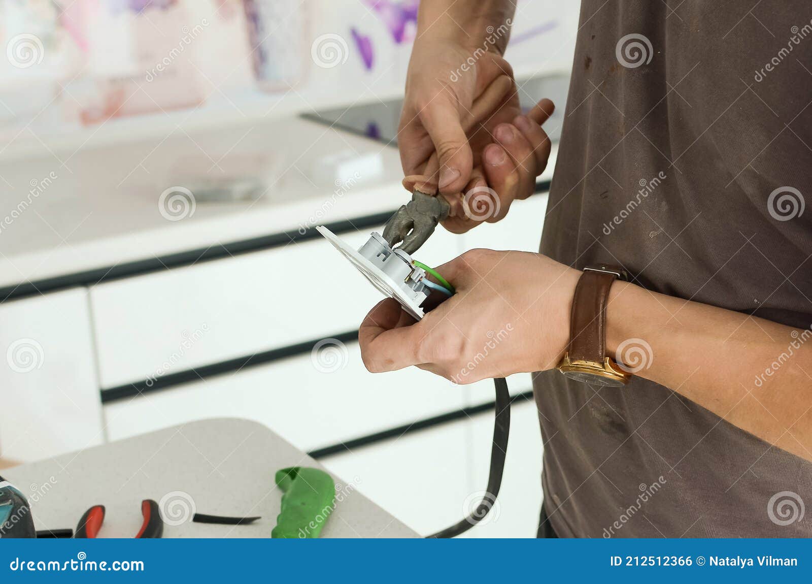 Installing an Electrical Outlet on a Kitchen Countertop Stock Photo