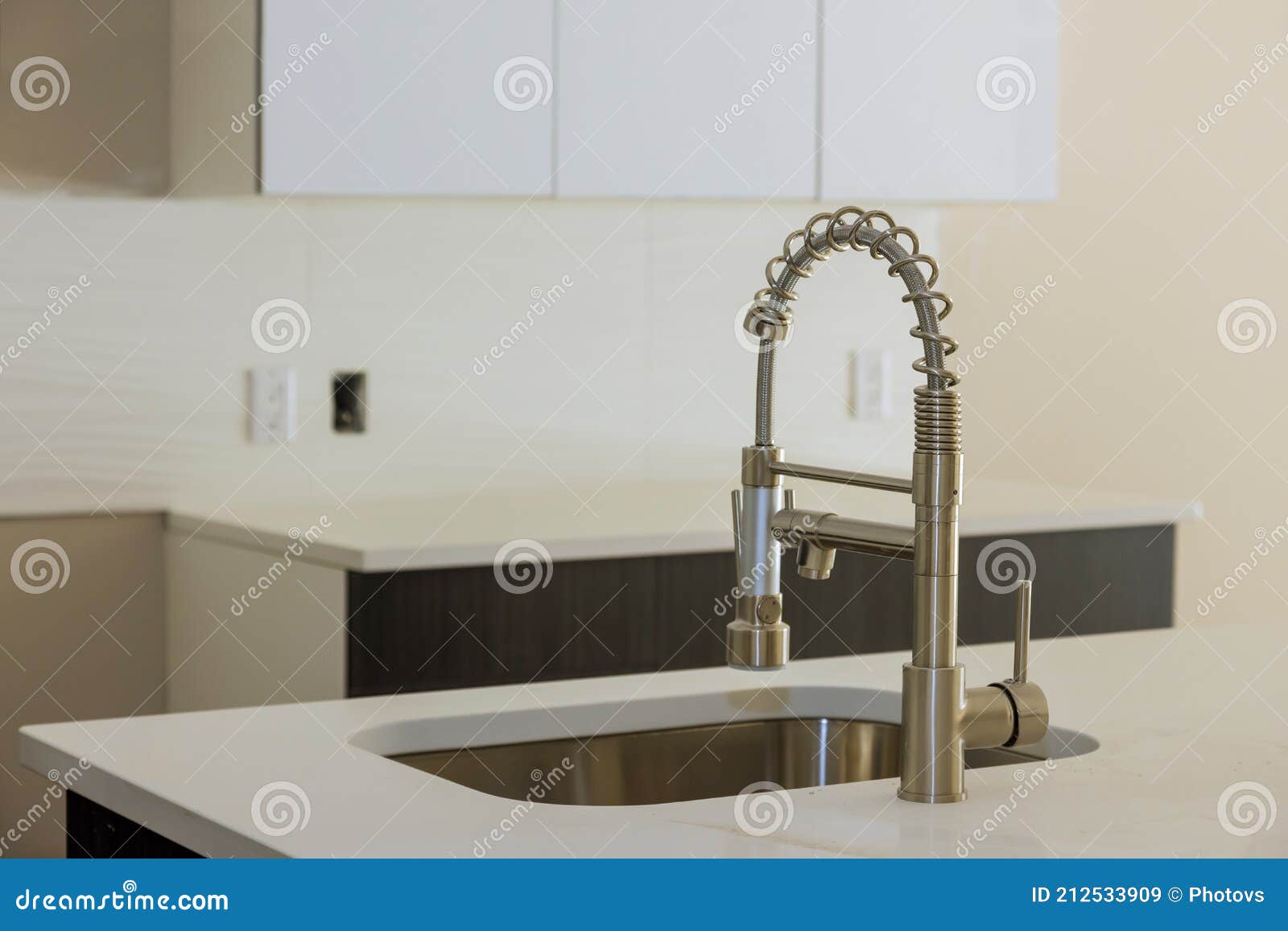 Installing New Sink Tape in the Kitchen Plumber with Island Sink Stock ...