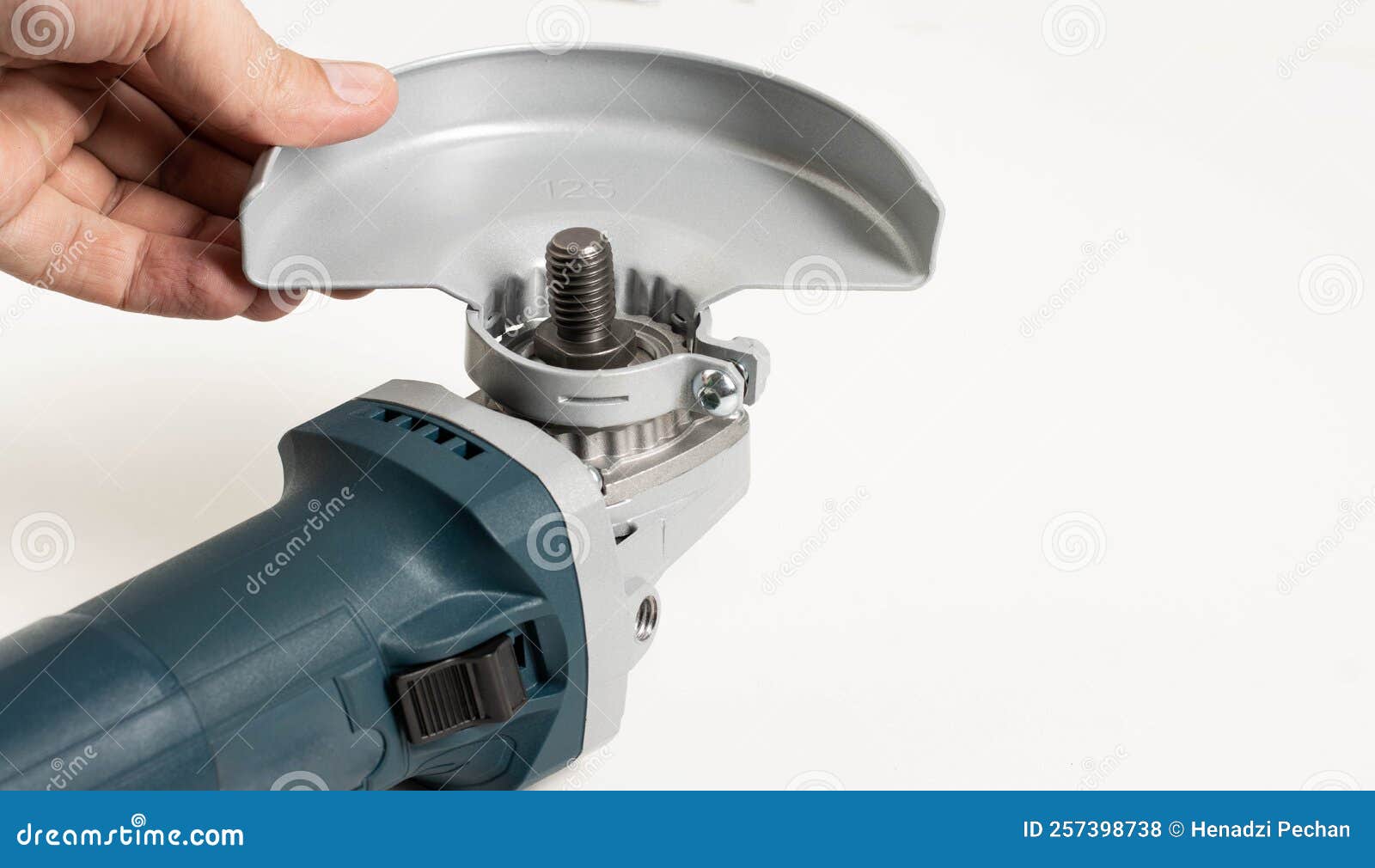 Installing the Safety Cover on an Angle Grinder, Closeup. Safety Precautions when Working with