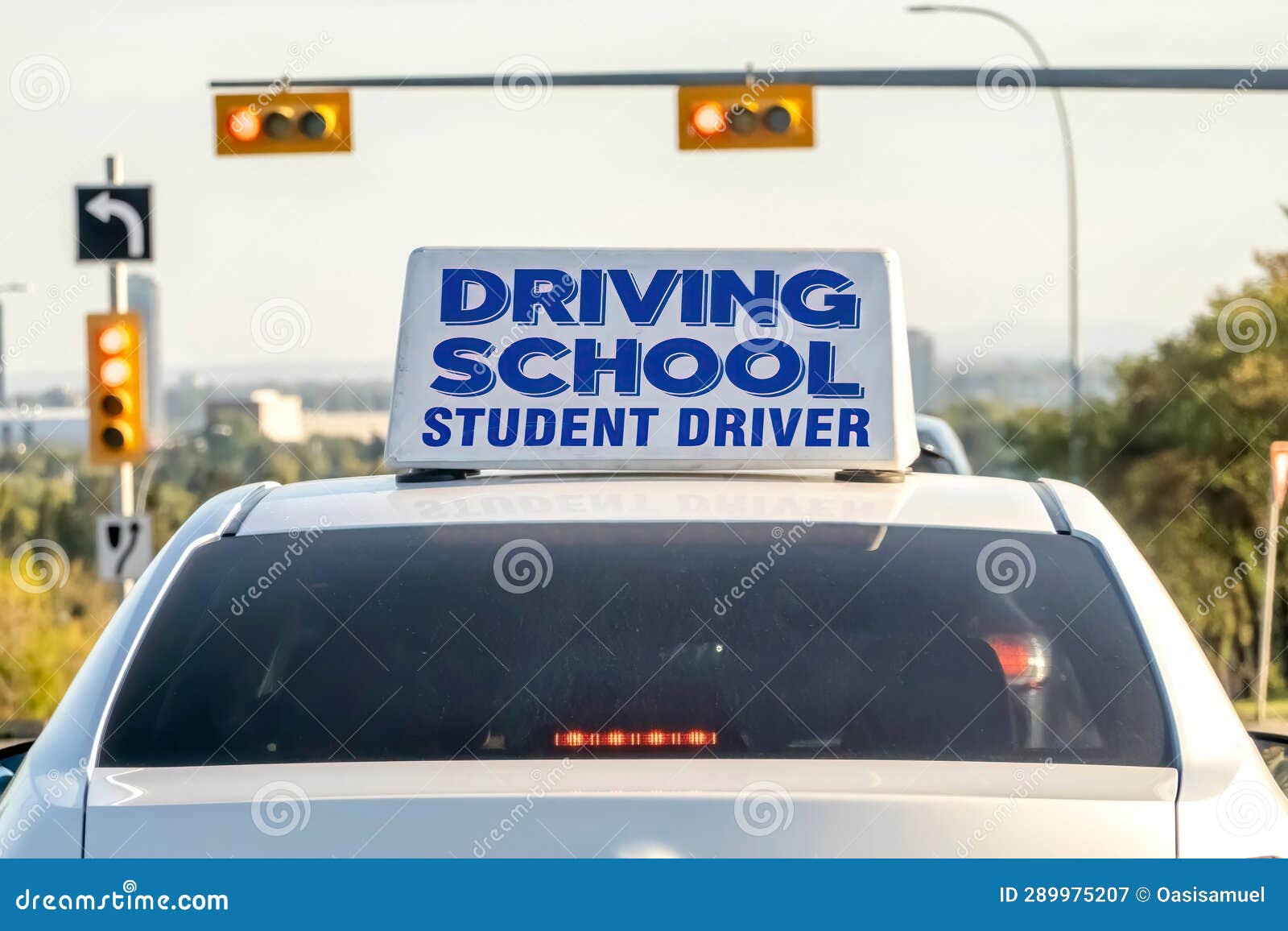 an instructional vehicle, bearing a prominent driving school student driver sign