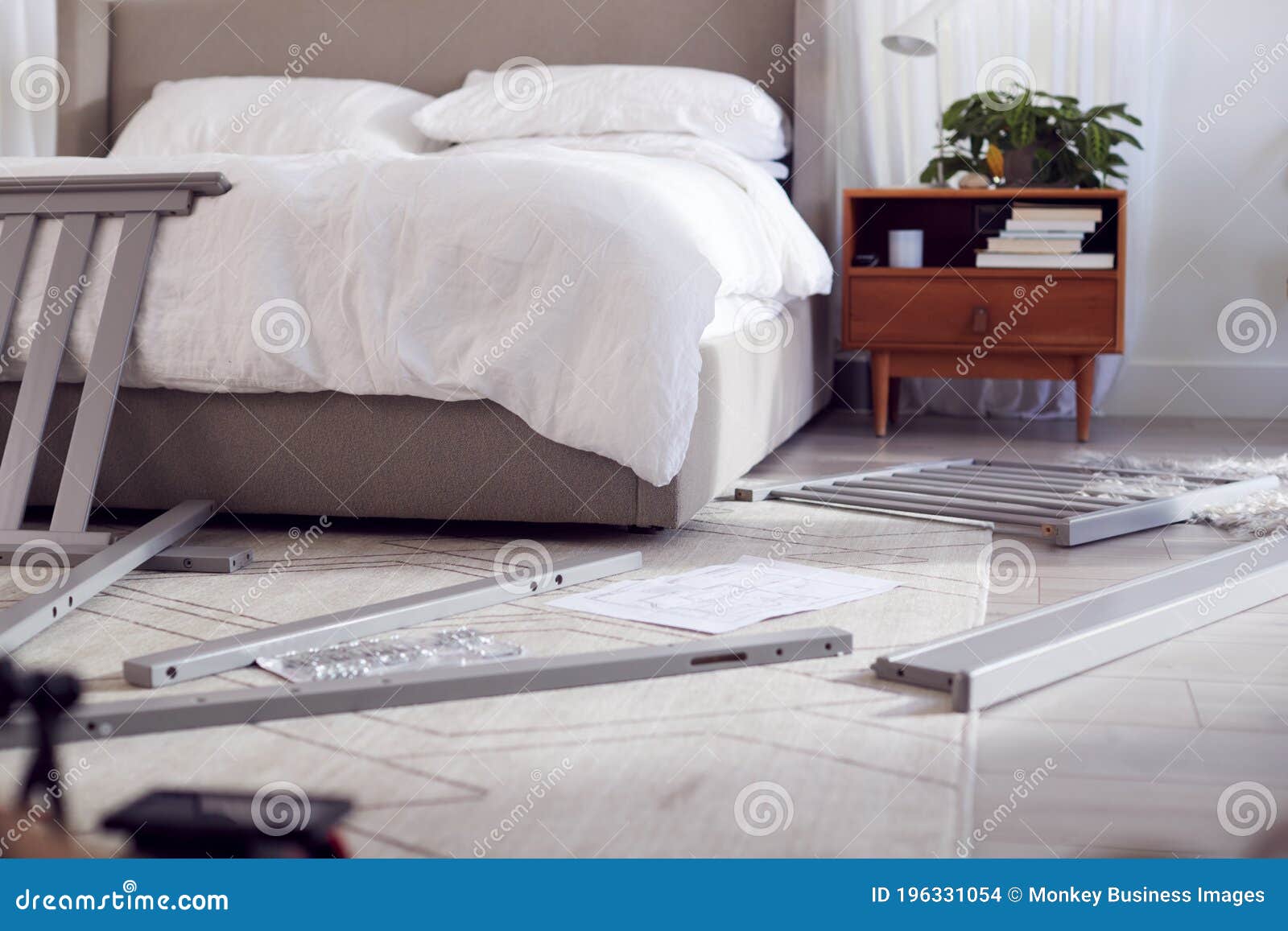 Instructions and Components for Self Assembly Baby Cot on Bedroom Floor