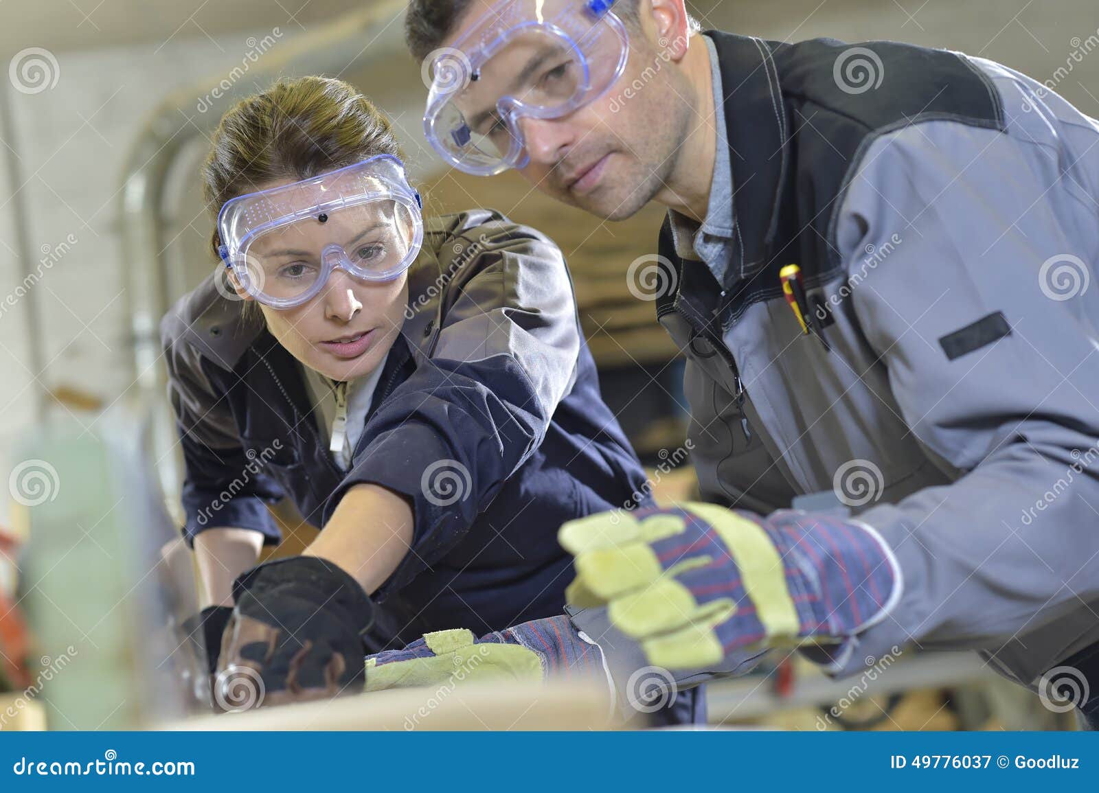 instructor showing trainee carpentry work