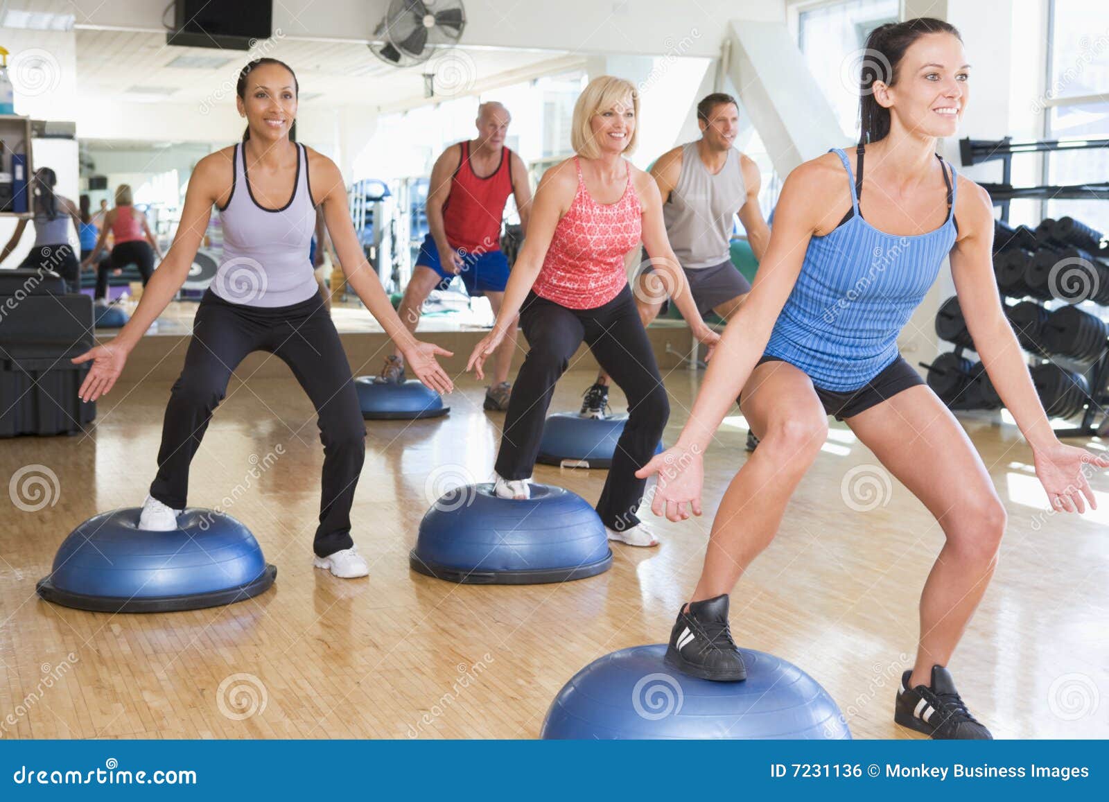 instructor taking exercise class at gym