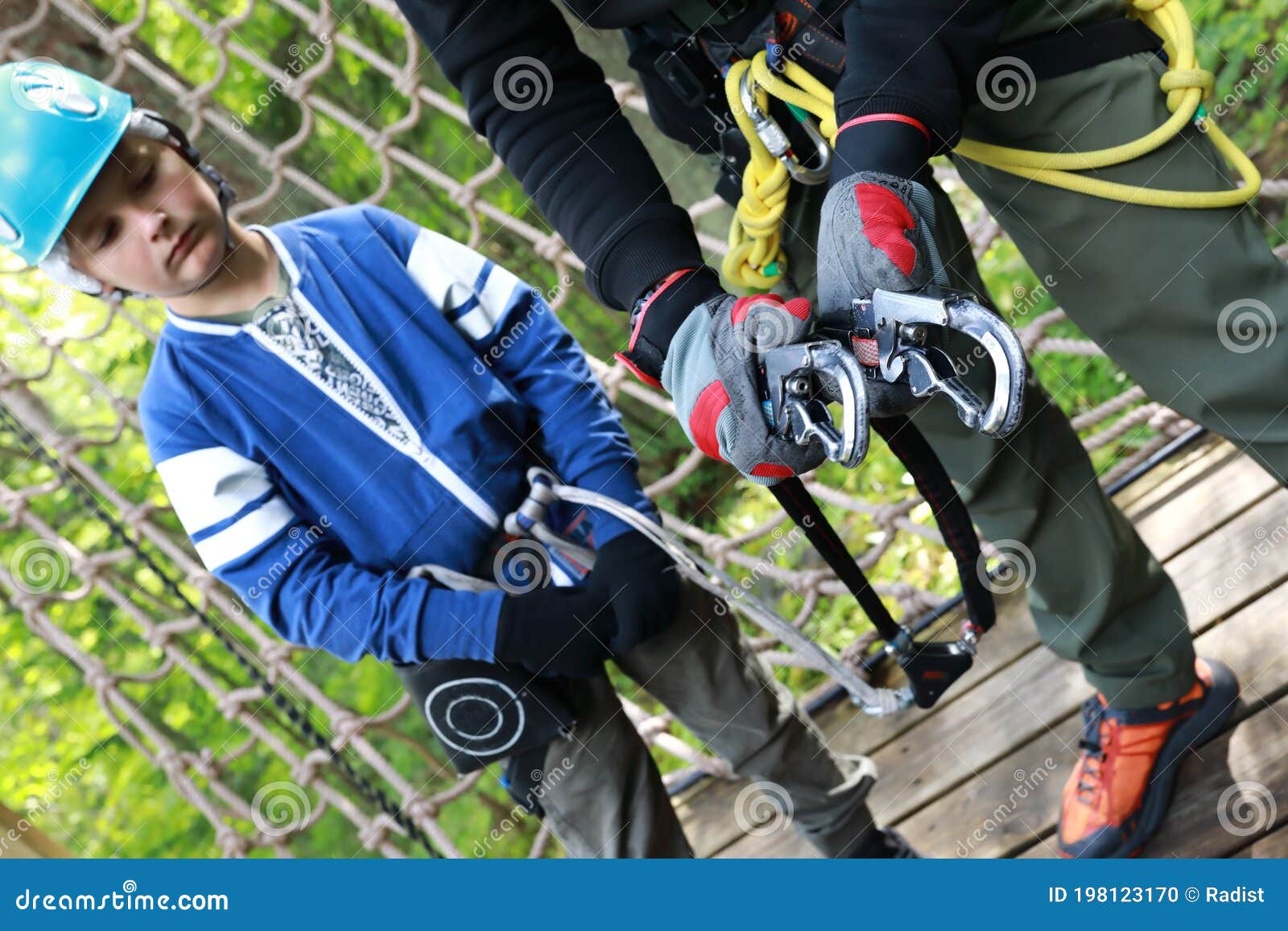 Instructor Teaches Child To Use Climbing Equipment Stock Photo Image