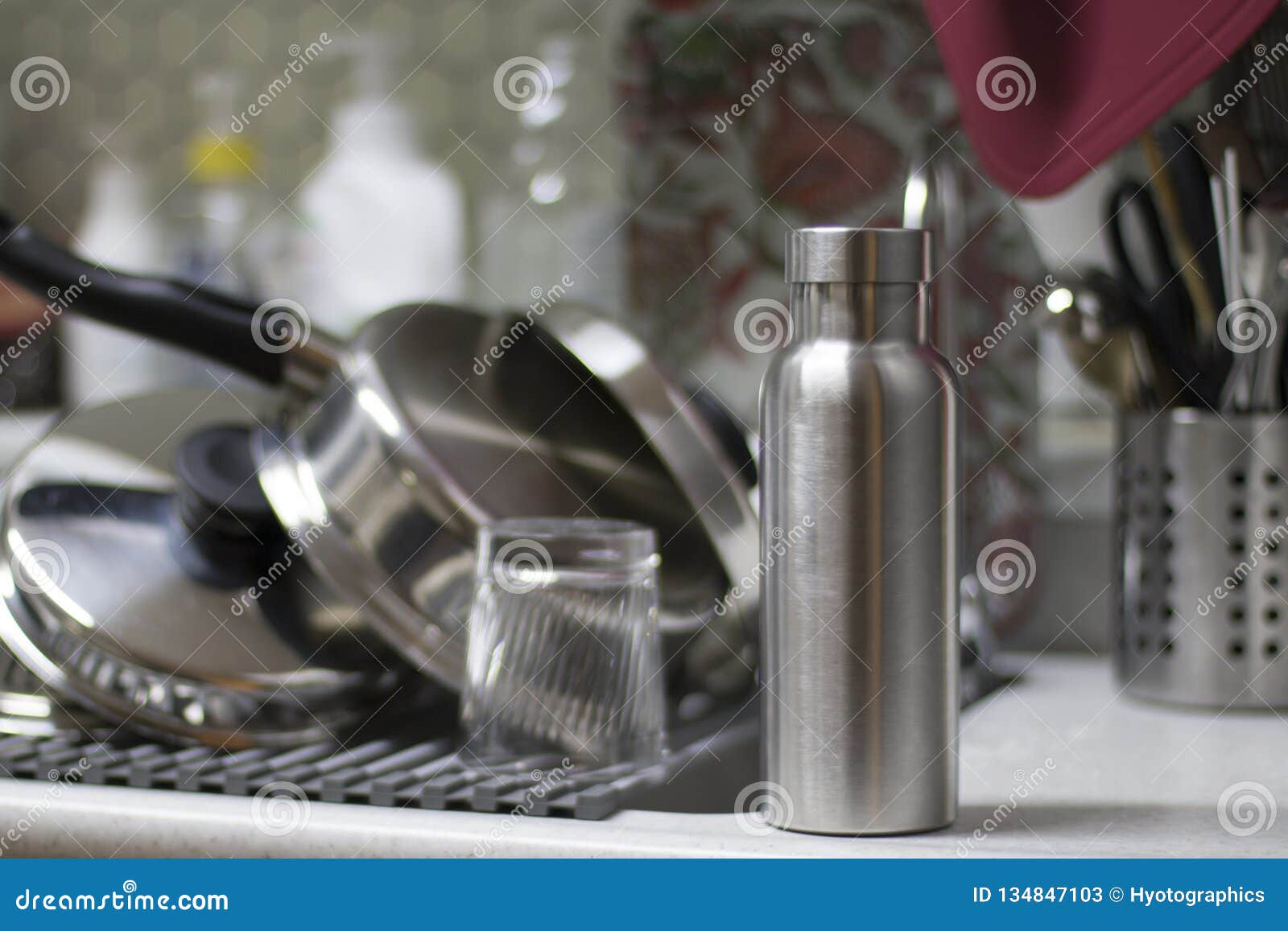 insulated stainless bottle with utensils and sink kitchen background