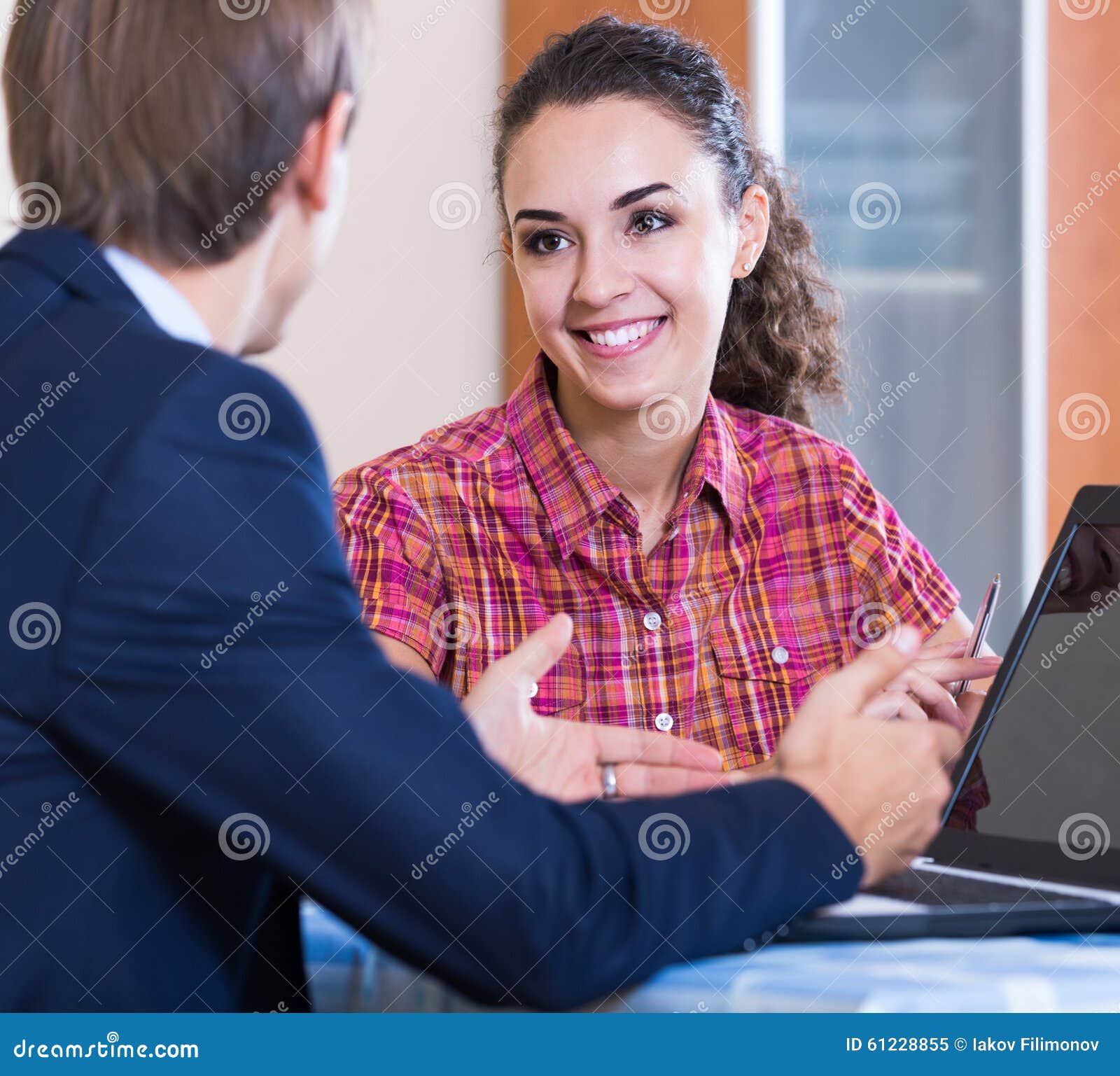 Insurance Agent and Customer Discussing Agreement Terms Stock Image
