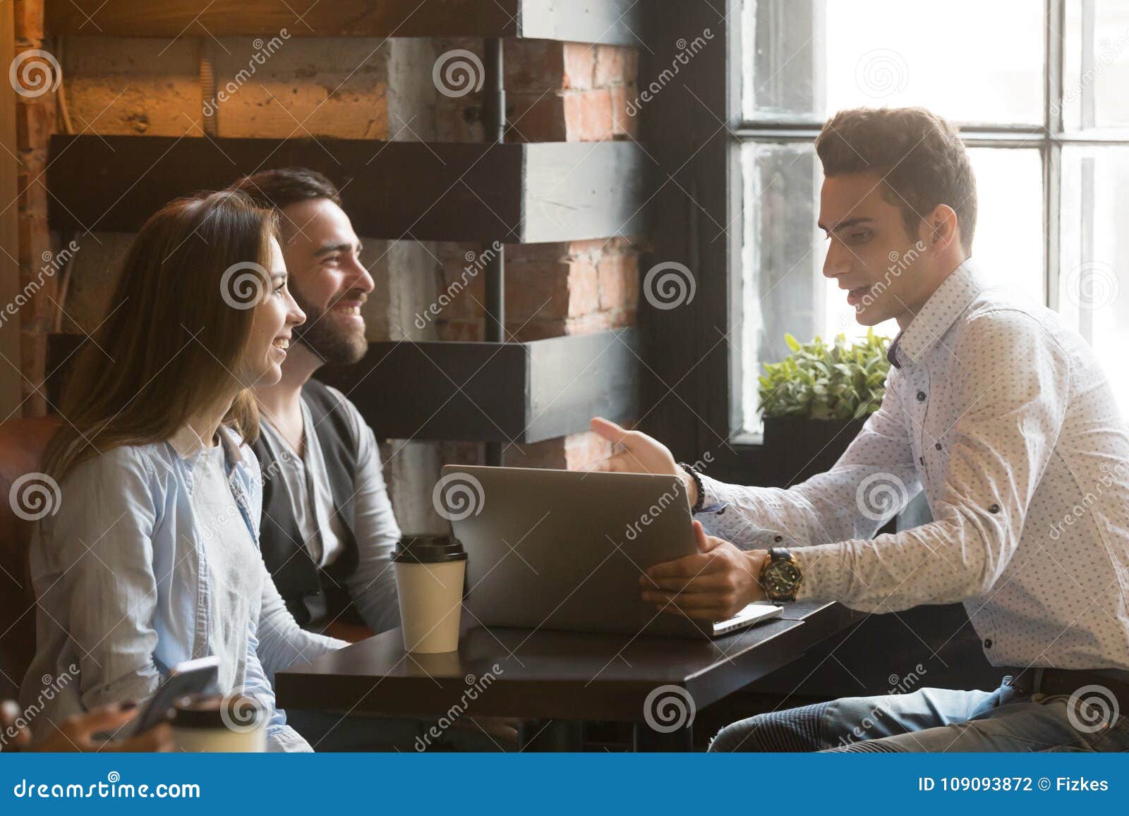 insurance broker or salesman making offer to couple in cafe