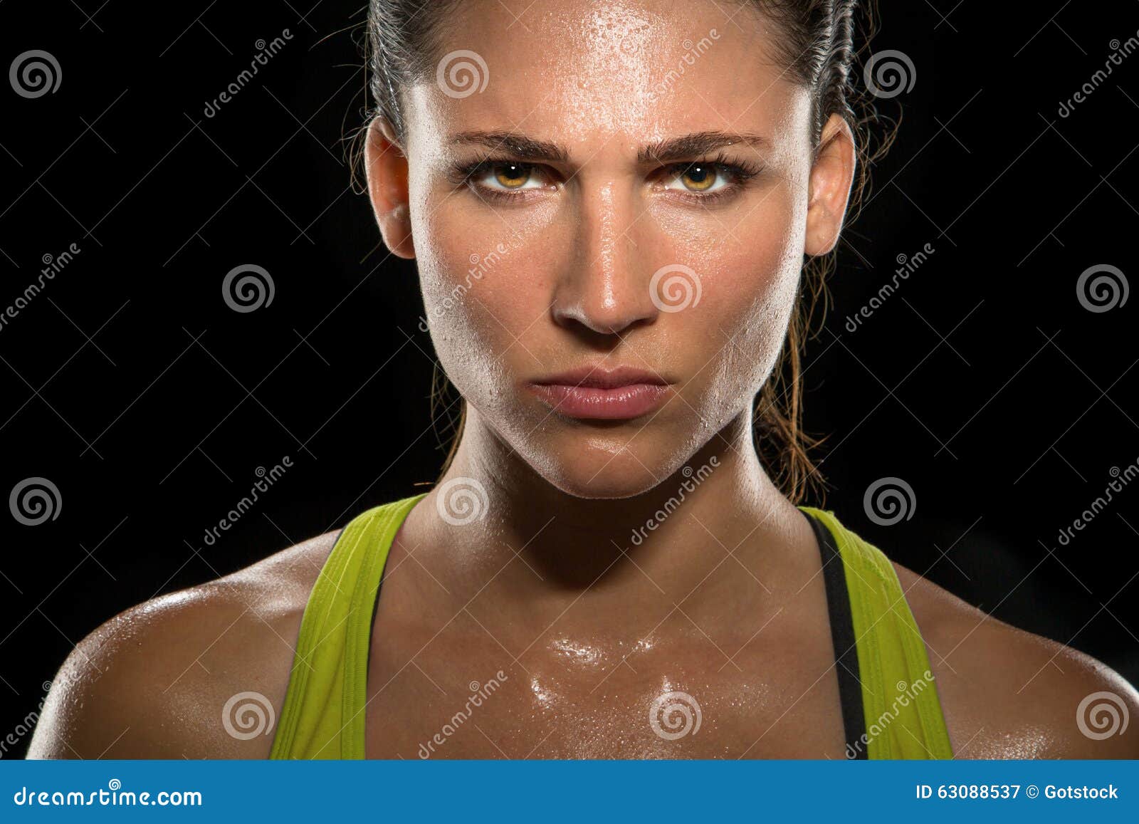 intense stare eyes determined athlete champion glare head shot sweaty confident woman female powerful fighter close up
