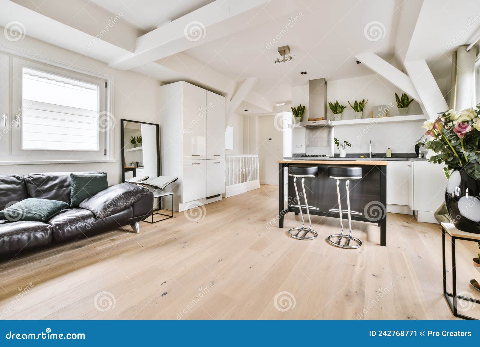The Interior of an Attractive Living Room with a Black Sofa Stock Image