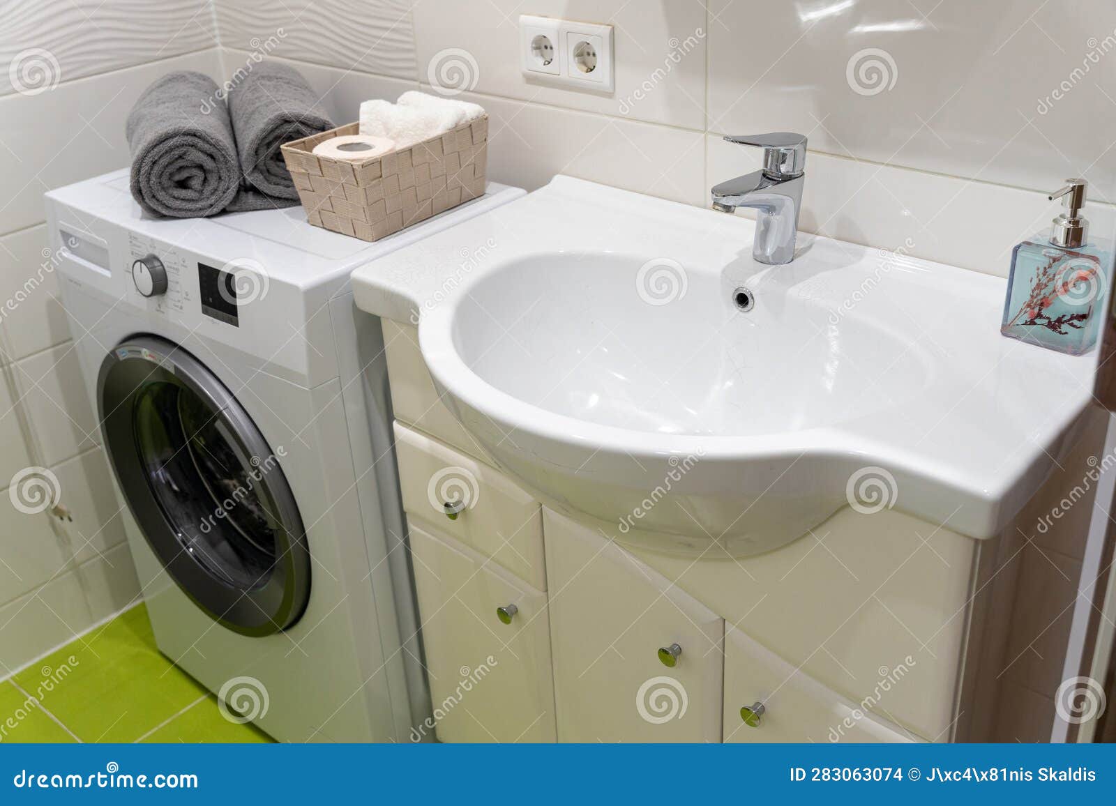 Interior of Bathroom with White Sink and Washing Machine Stock Photo