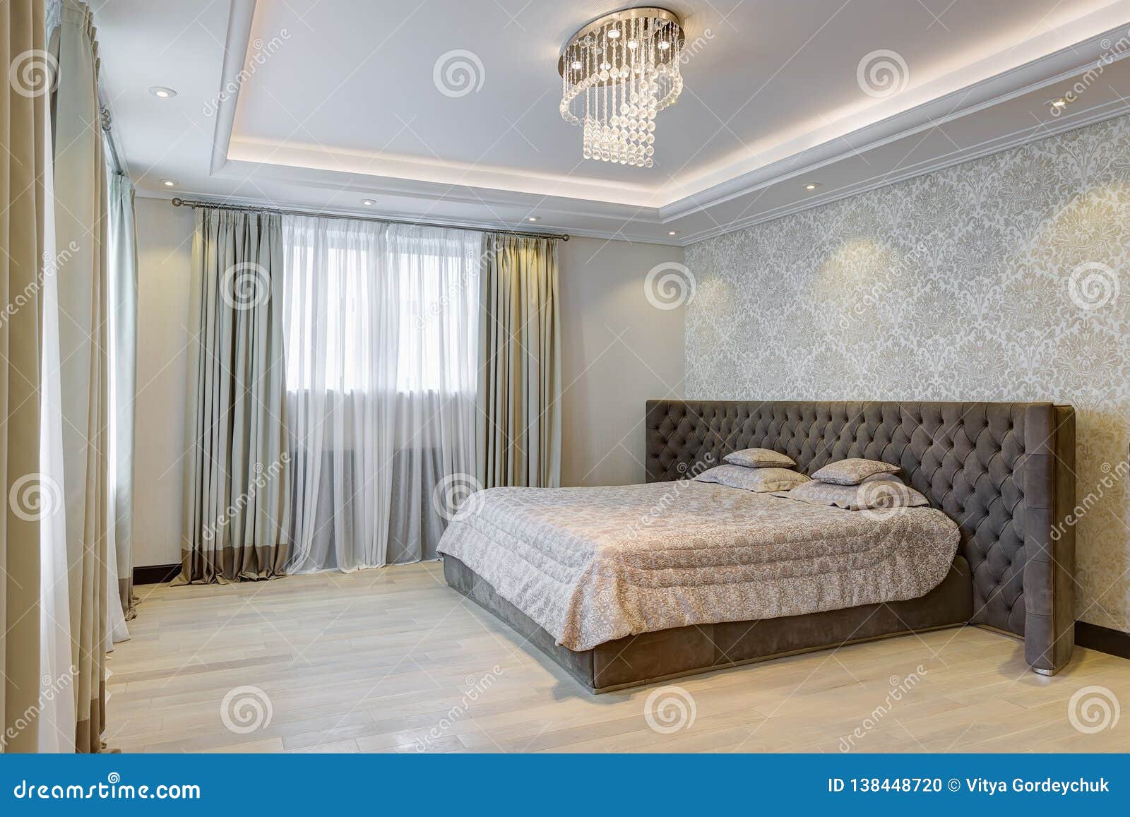 Interior Of Gray Bedroom With Crystal Chandelier Stock