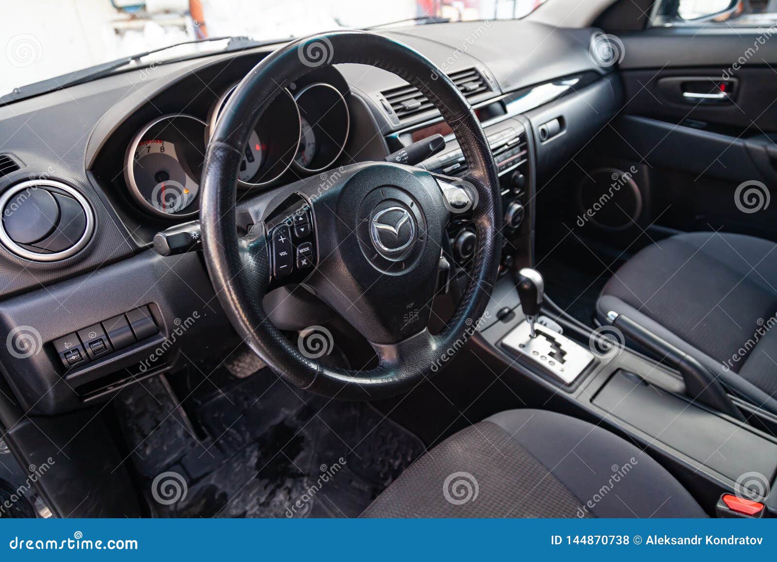The Interior Of The Car Mazda 3 With A View Of The Steering