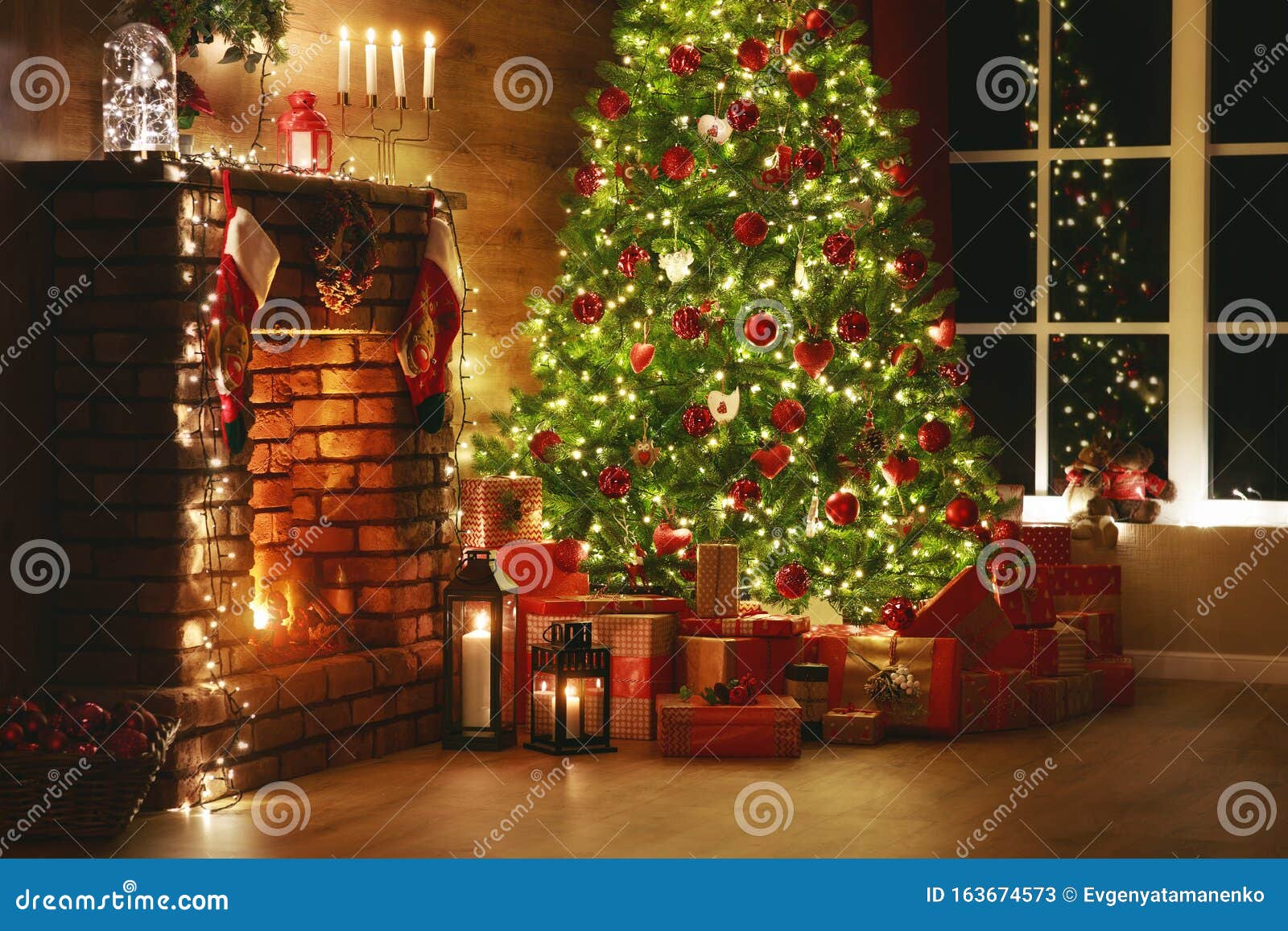 Interior Christmas. Magic Glowing Tree, Fireplace, Gifts in Dark Stock