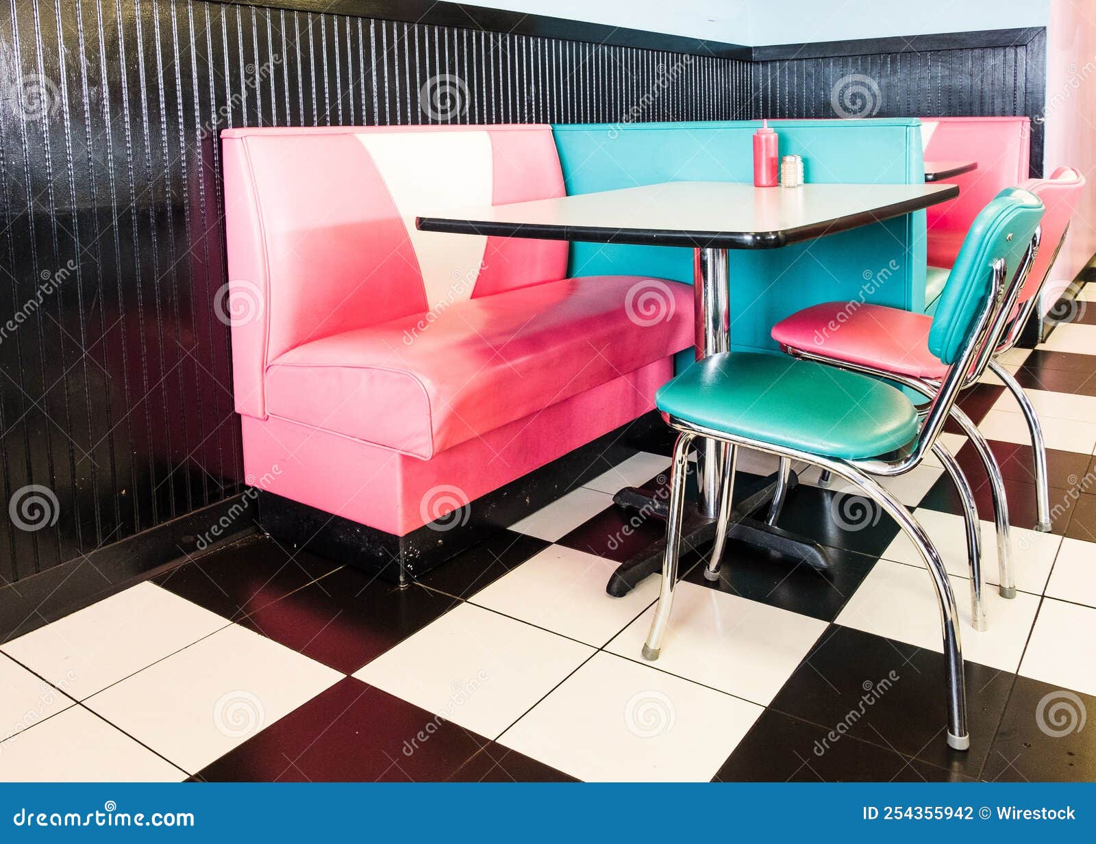 Interior of a Classic American 1950s Style Diner with Colorful Stools