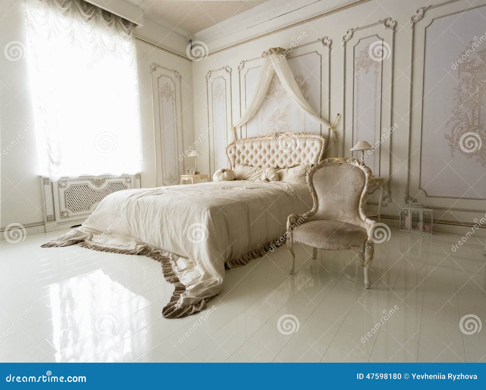 Interior Of Classic White Bedroom With Big Bed And Chair Stock Photo