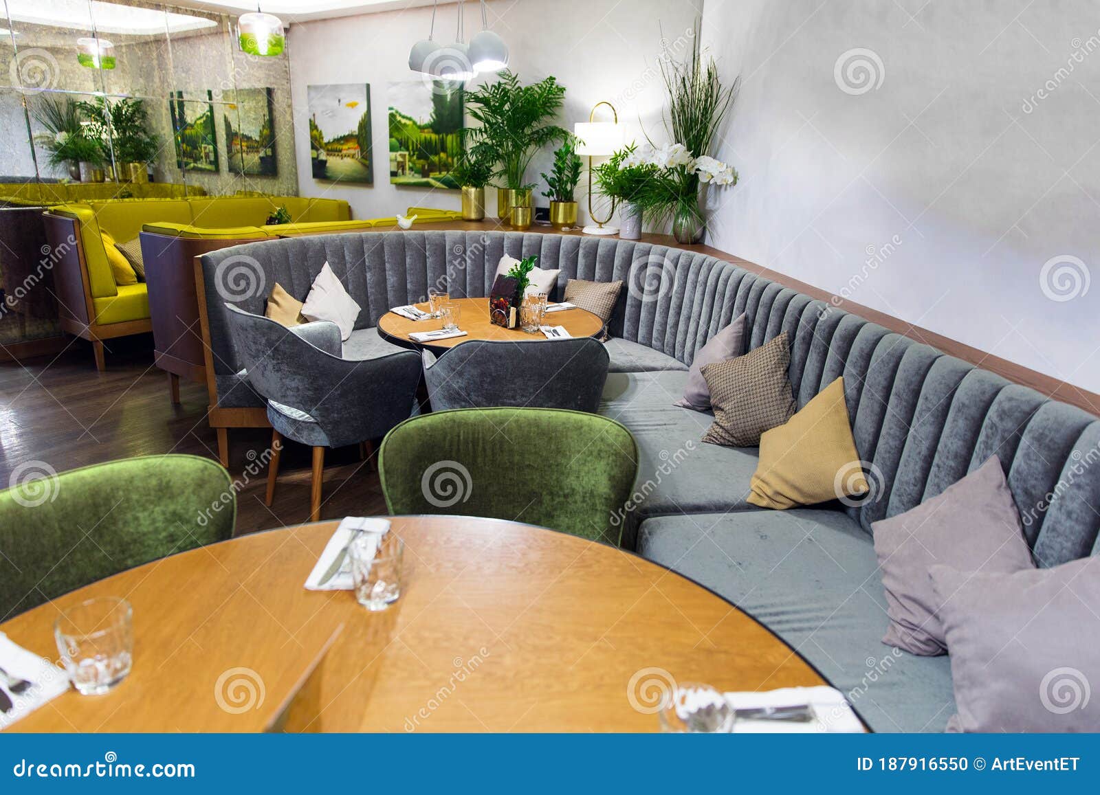 Interior of Cozy Modern Restaurant with Soft Sofas and Armchairs Stock