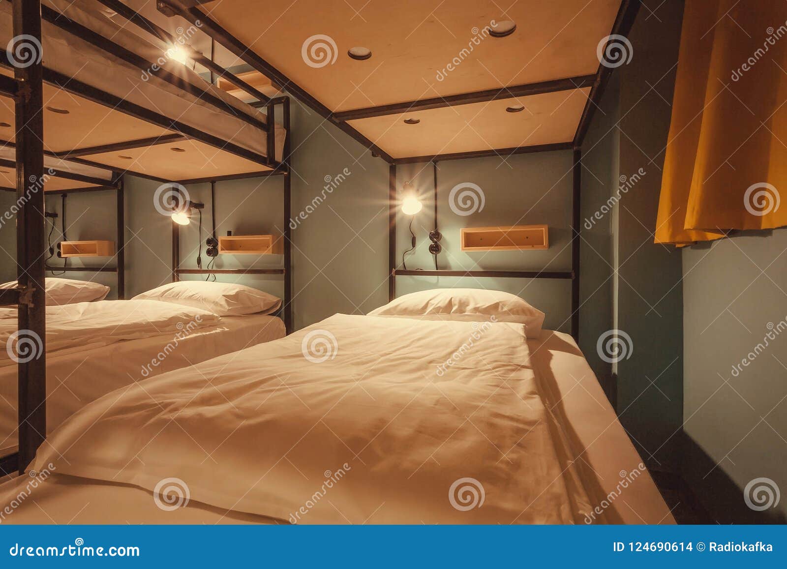 interior  of a dorm room of tourist hostel with clean beds for twelve people