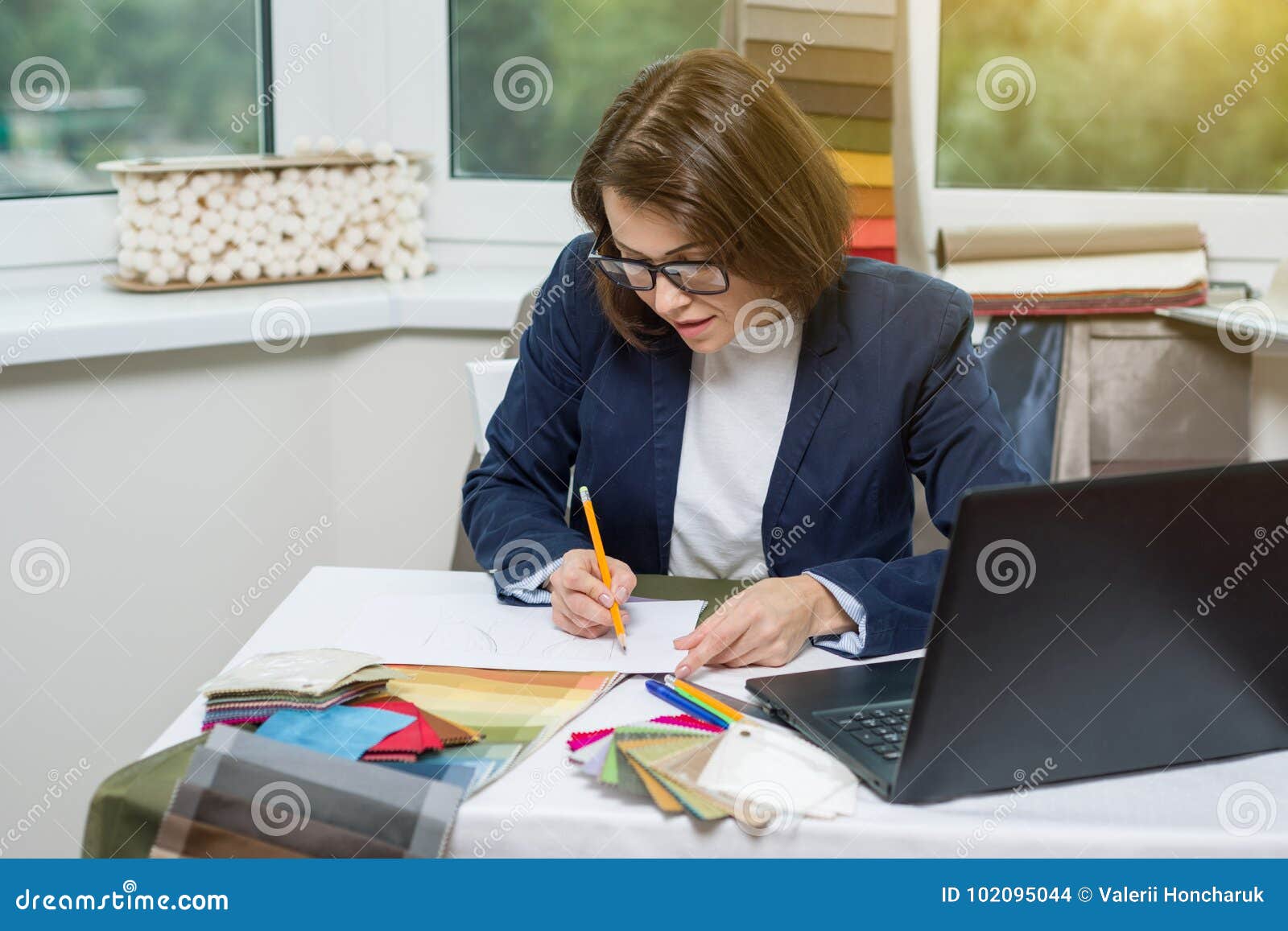 Interior Designer At The Workplace With Samples Of Fabrics