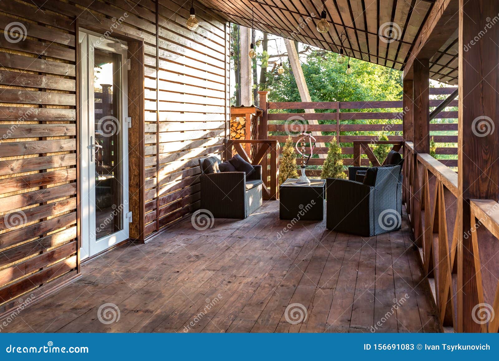 interior of empty hall veranda in wooden village vacation home with vintage lamps and chairs