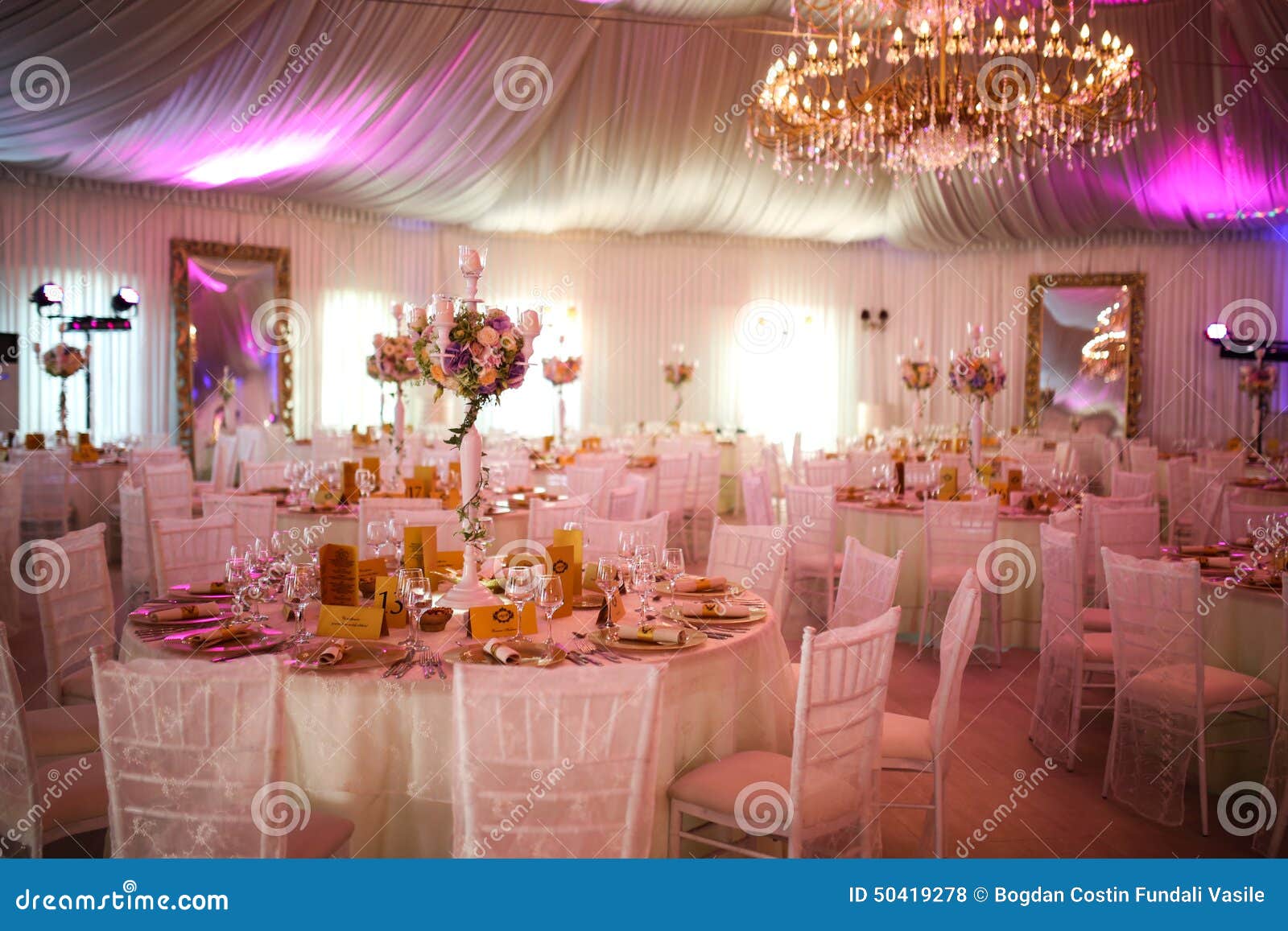 interior of a luxury white wedding tent decoration ready for guests