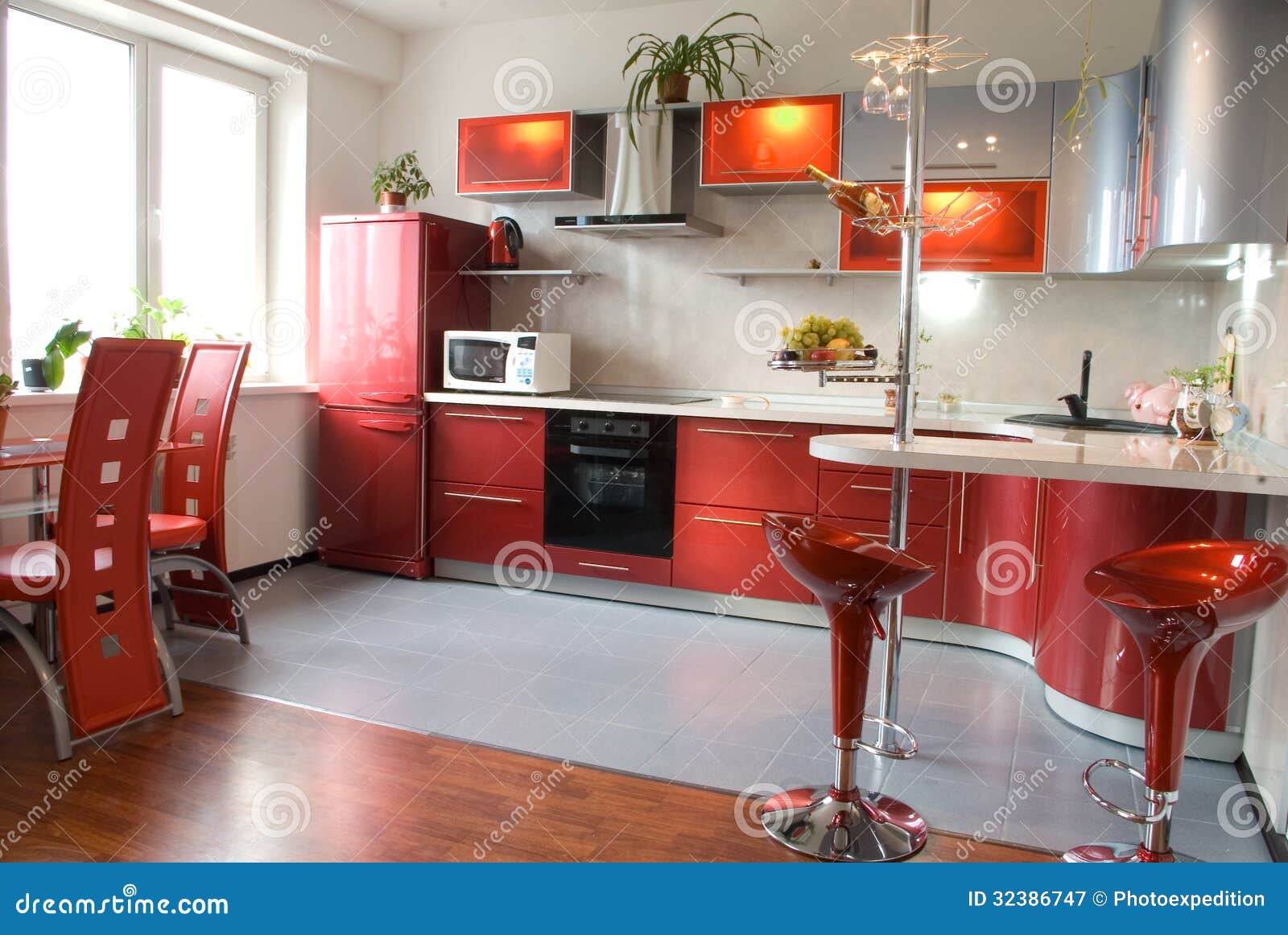 Interior of Modern Kitchen with a Bar Counter in Red Tones Stock Image