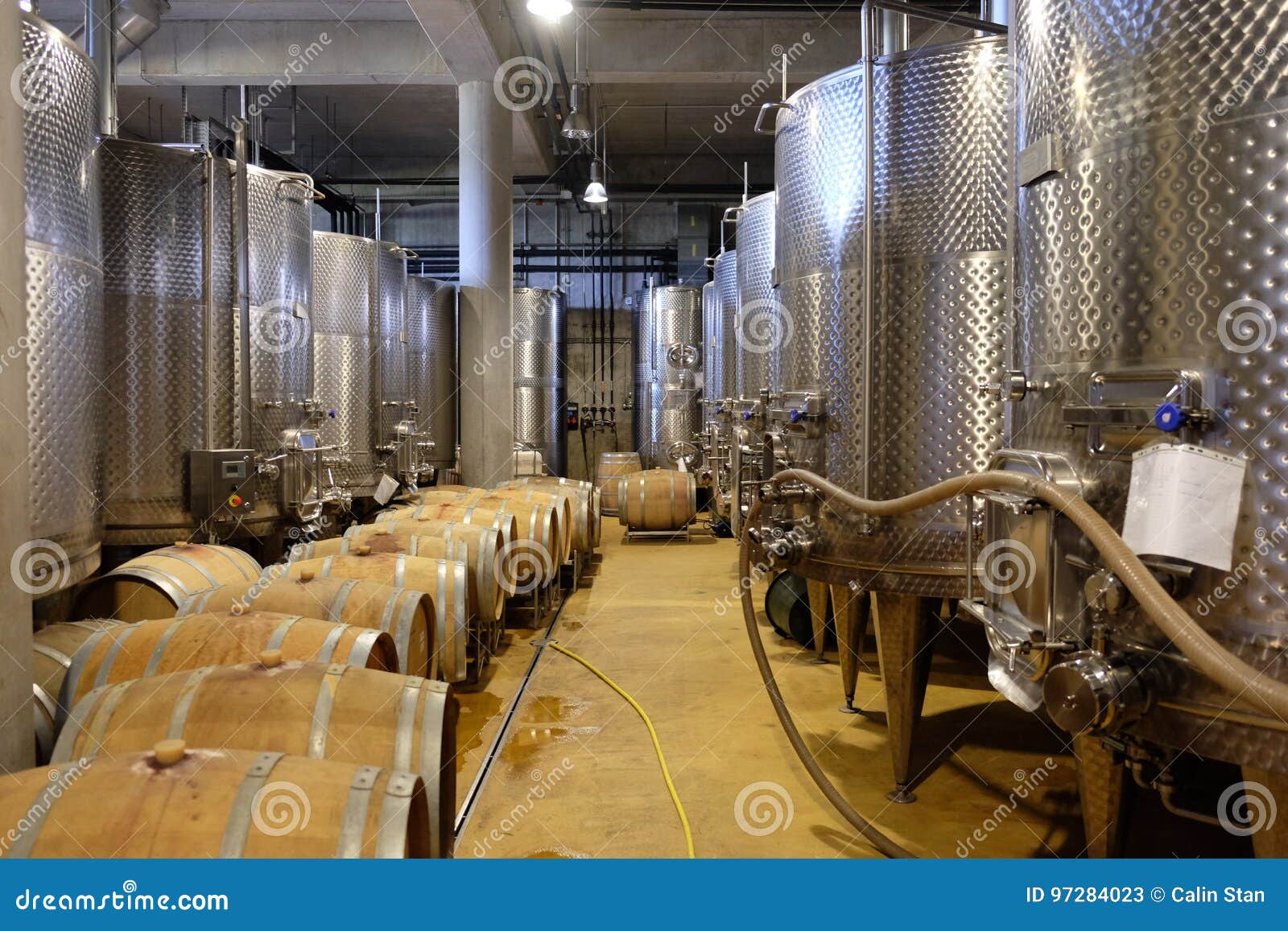 Interior of a Modern Underground Winery with Aluminium Tanks and Stock