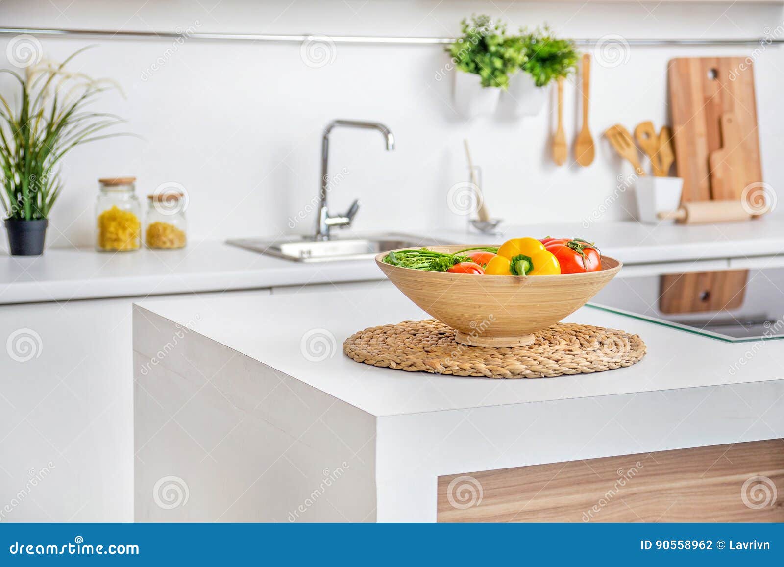 Interior of Modern White Kitchen with Induction Cooking Heater an Vegetables on the Table Stock