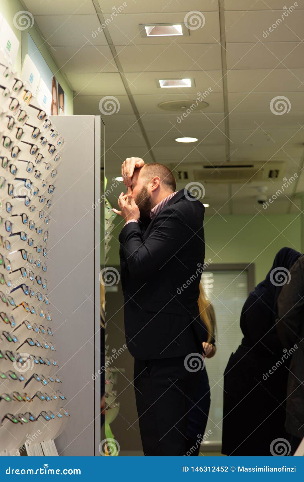 Interior of a Optician Store with Costumers Looking for Spectacles
