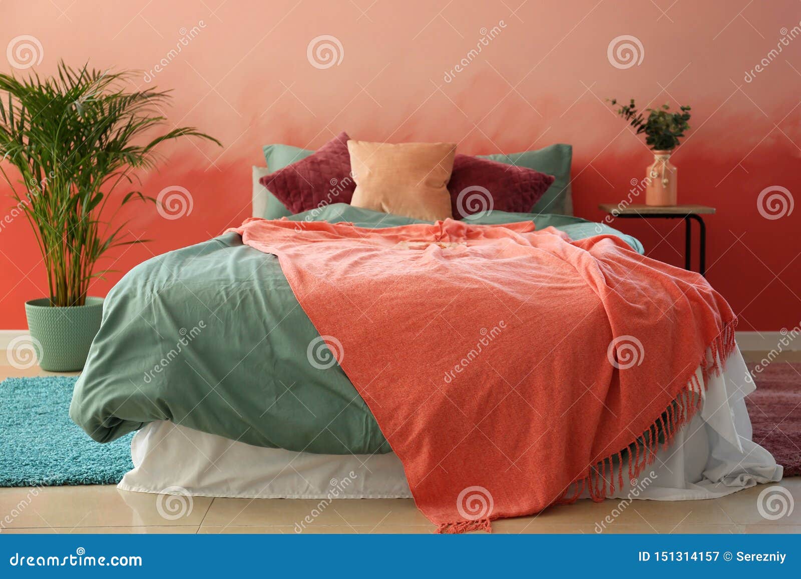 Interior of Room with Comfortable Bed Near Pink Wall Stock Image
