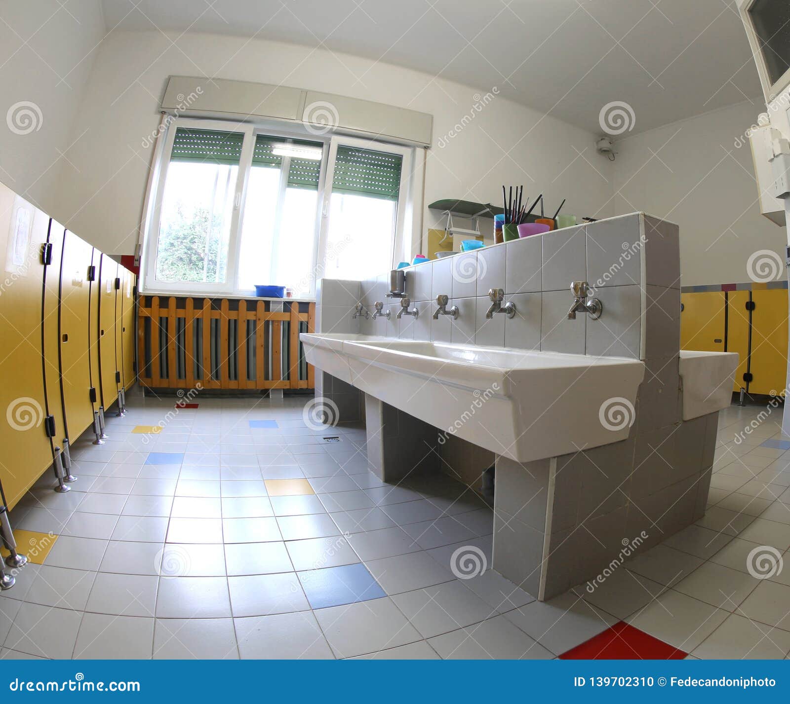 Interior of the School Bathrooms with Ceramic Sinks and Yellow D Stock