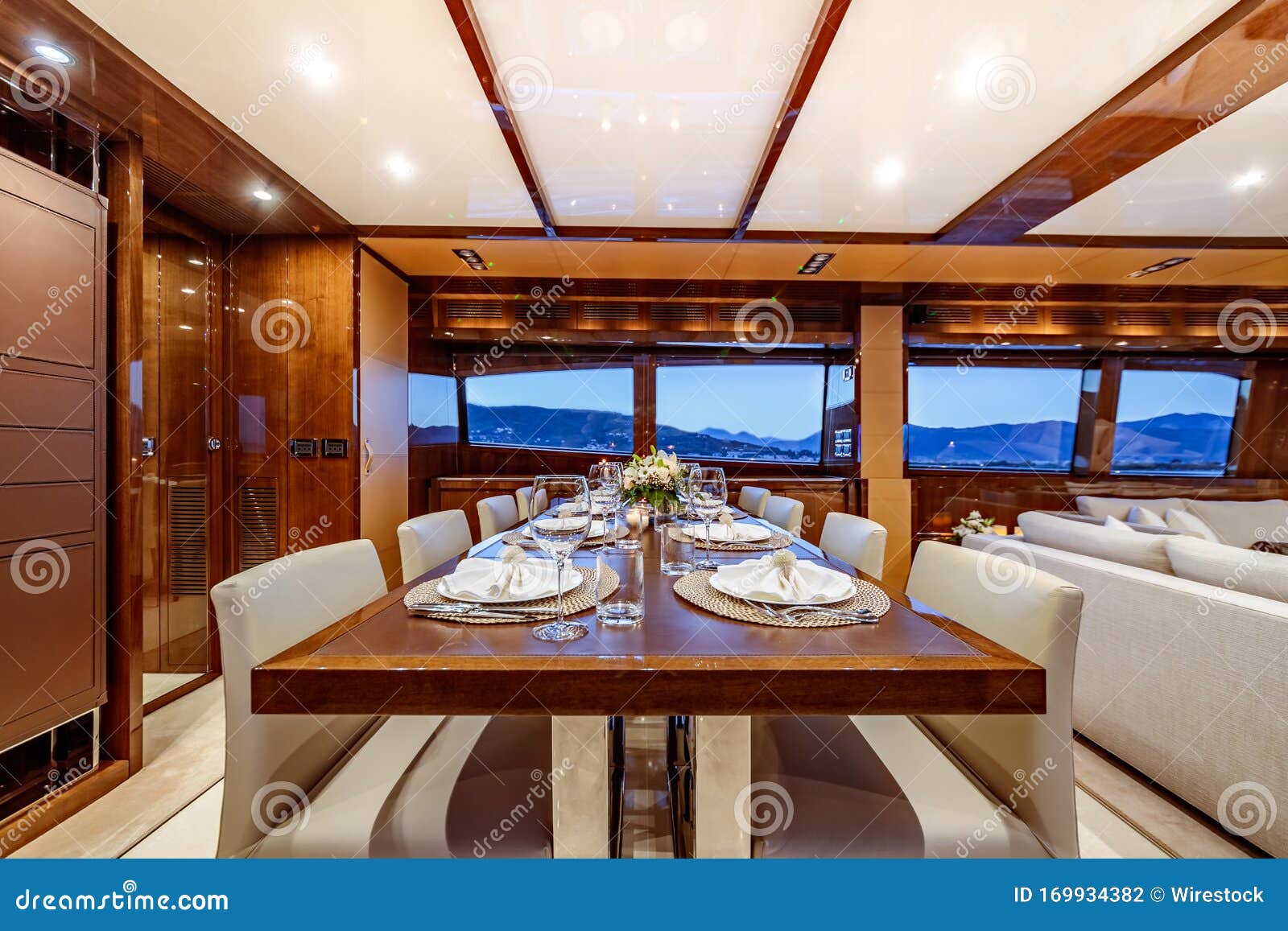 Interior Shot of a Yacht with a Dining Table and Couches Stock Photo