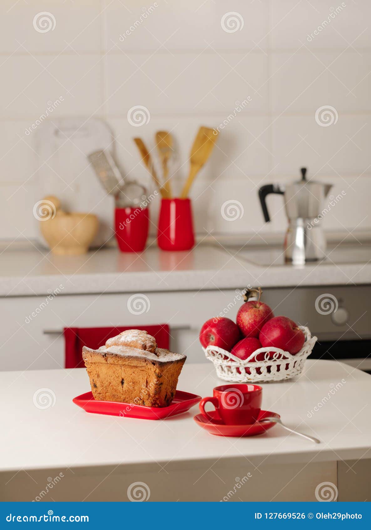 Interior White Kitchen with Kitchen Tools and Red Crockery. Stock Photo