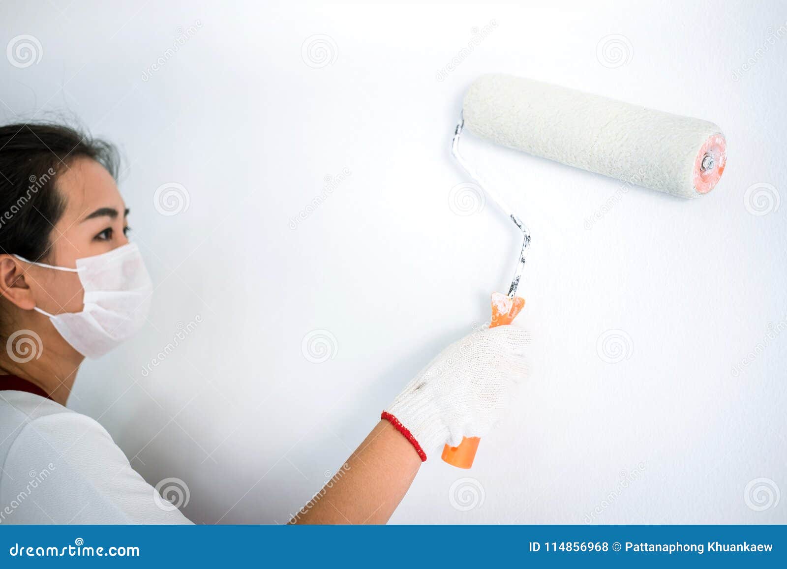 Interior Working, Painter Hand in White Glove Painting Wall with Stock