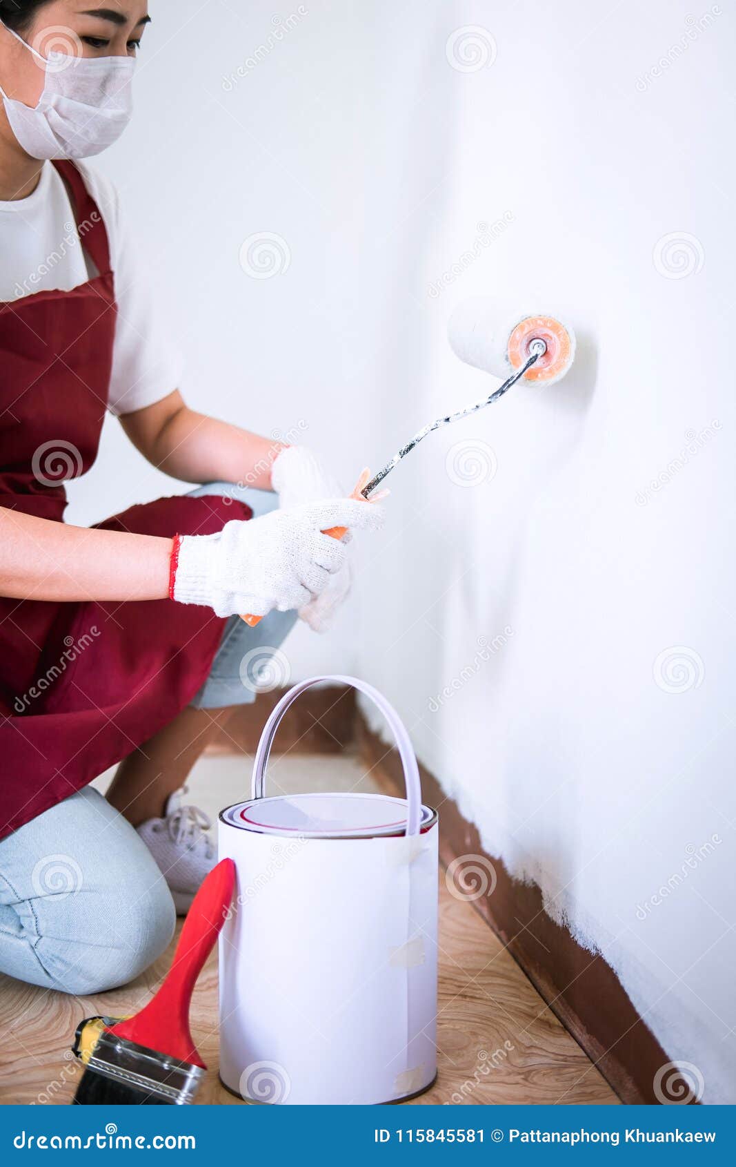 Interior Working, Painter Hand in White Glove Painting Wall with Stock