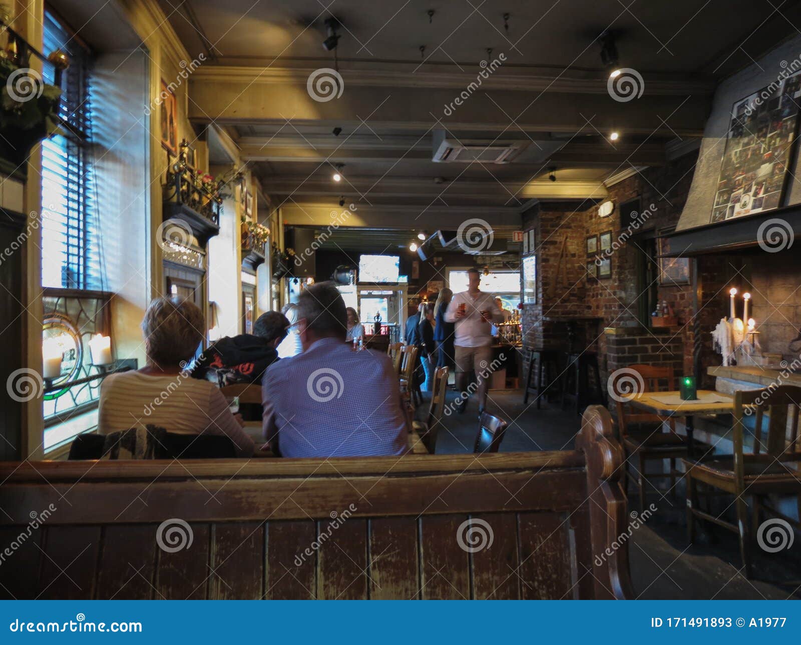 Interiors of an Irish Pub with Costumers in Oslo Editorial Stock Photo